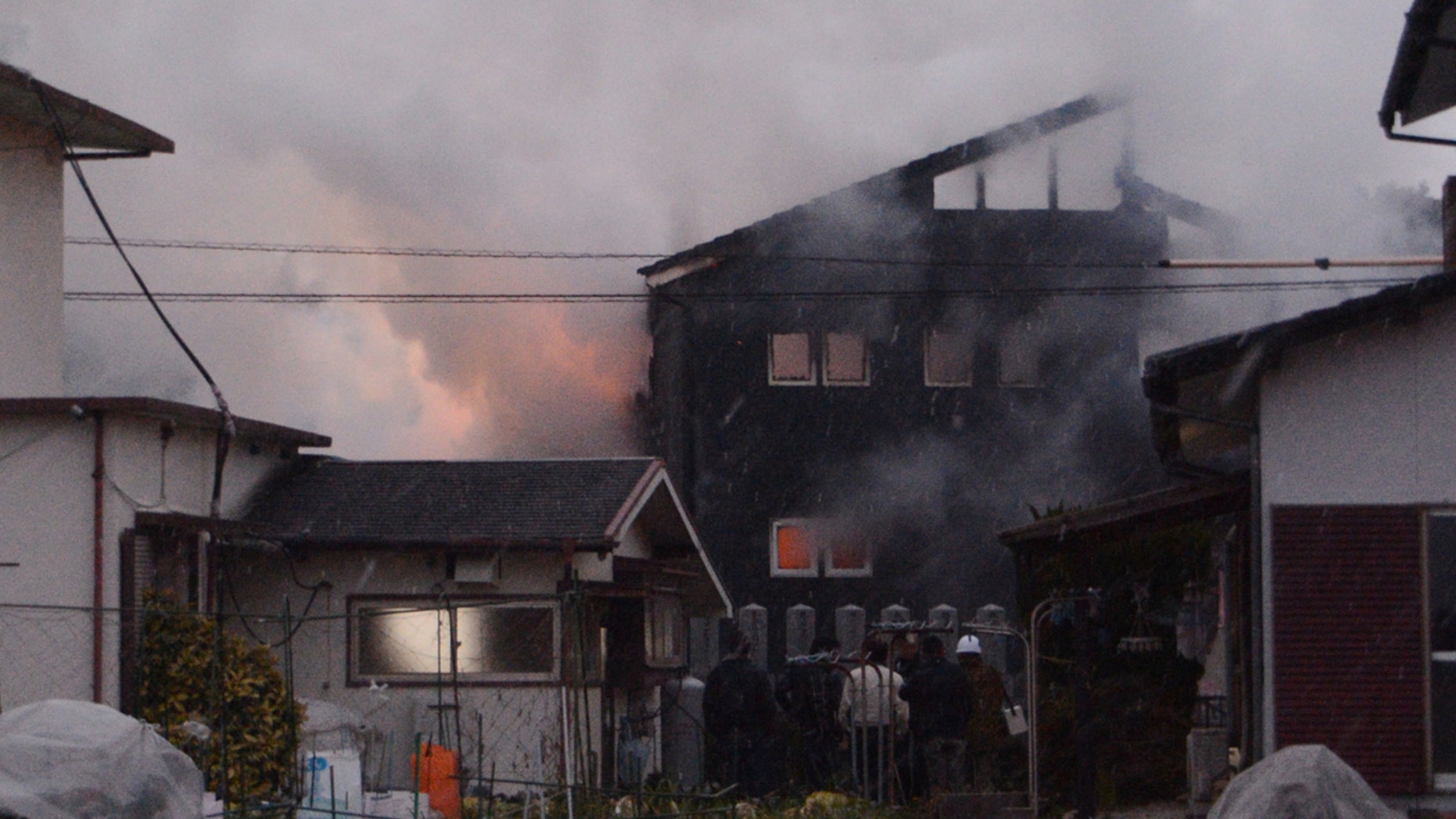 Smoke billows from the site where a Japanese military helicopter crashed in Kanzaki on Monday.