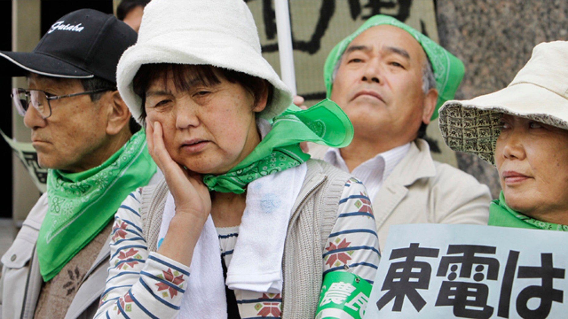 April 26: Farmers, mostly from Fukushima Prefecture where the tsunami crippled Fukushima Dai-ichi plant is located, hold a protest in front of the Tokyo Electric Power Co. (TEPCO) headquarters in Tokyo Tuesday. More than 200 farmers affected by radiation spewing from the nuclear plant staged a demonstration to demand that TEPCO pays them adequate compensation for loss of income caused by having to leave their farms, or for having produced withdrawn from the market due to contamination fears. The placard at right reads: "TEPCO, compensate!" (AP)