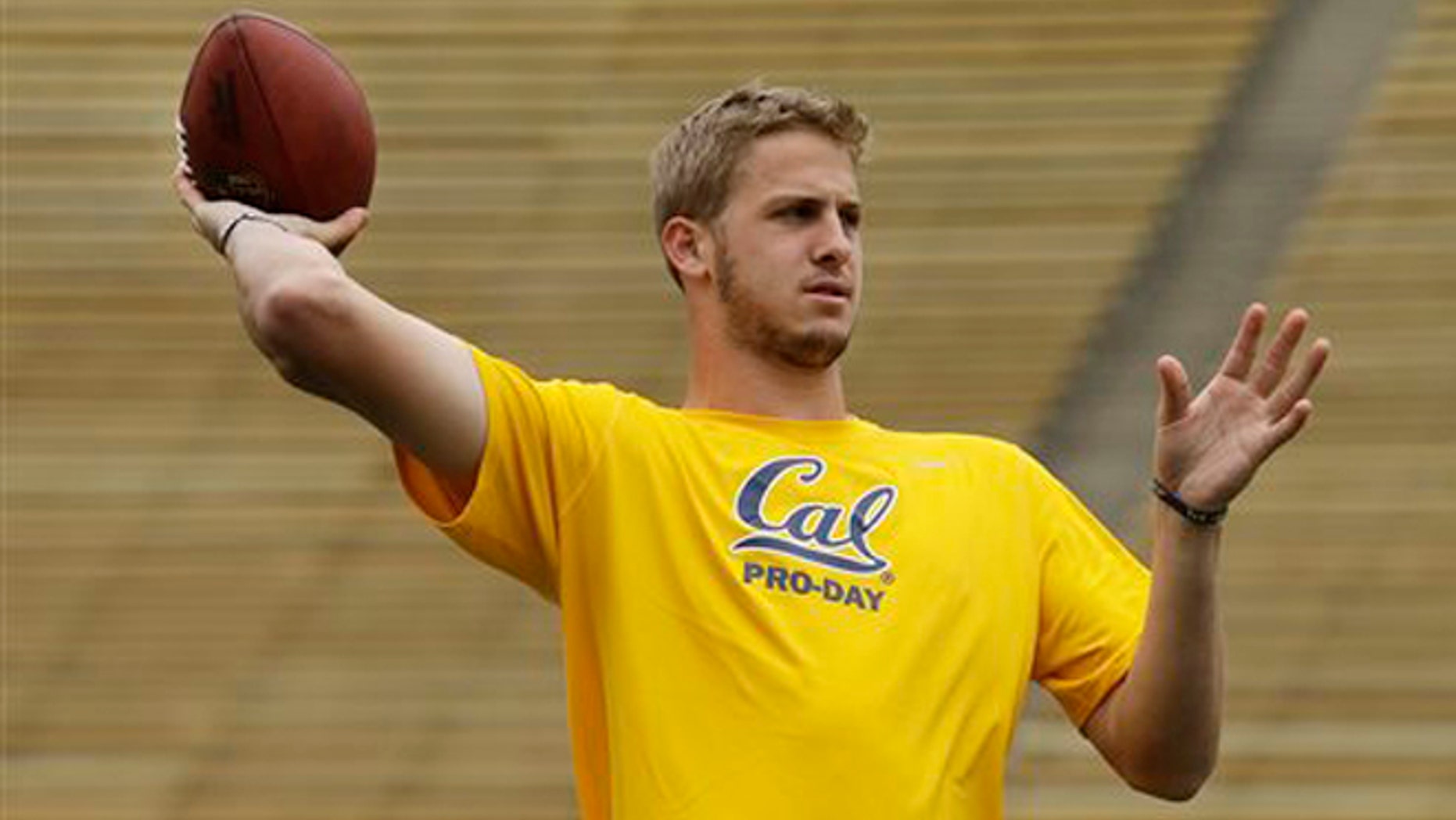 FILE - In this March 18, 2016 file photo, California quarterback Jared Goff passes during California's NFL Pro Day in Berkeley, Calif. Even in a year when the quarterbacks don't appear to be slam-dunk naturals to make it big in the NFL, that's where the focus will be when the draft begins Thursday night, April 28, in Chicago. (AP Photo/Ben Margot, File)