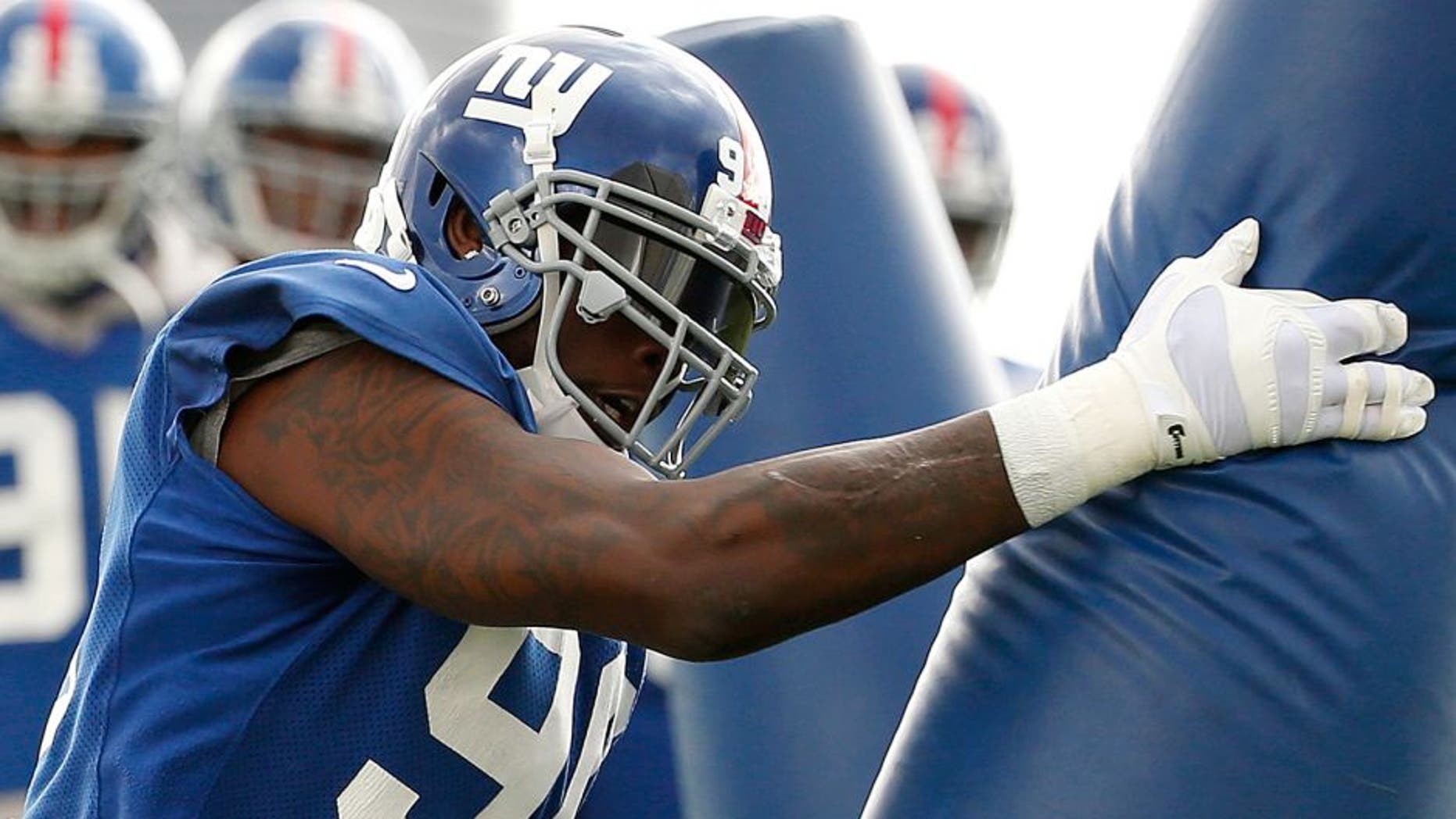 New York Giants defensive end Jason Pierre-Paul works out during NFL football practice, Thursday, Oct. 29, 2015, in East Rutherford, N.J. The two-time Pro Bowl defensive end is back more than three months after losing a finger in a July 4 fireworks accident. His right index finger was amputated, his thumb was injured and his hand sustained burns in the accident. (AP Photo/Julio Cortez)