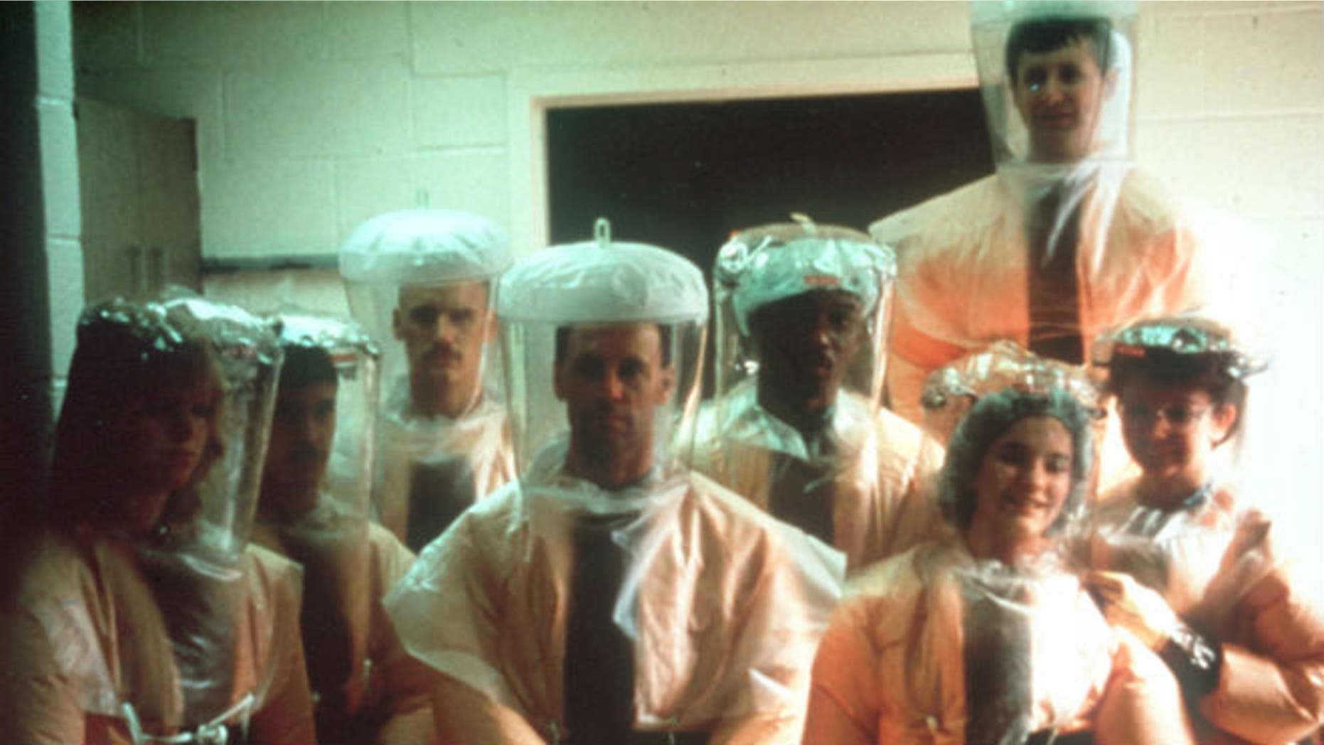 This handout photo provided by Dr. Jerry Jaax, taken in Dec. 1989, shows the Veterinary Medicine Division team from US Army Medical Research Institute of Infectious Diseases (USAMRIID) in the hot zone, Nonhuman primate quarantine facility in Reston, Va. As it turns out, Americans’ introduction to the deadly Ebola virus 25 years ago came courtesy of an outbreak that turned out to be completely nonlethal to humans. (AP Photo/Gerald Jaax)