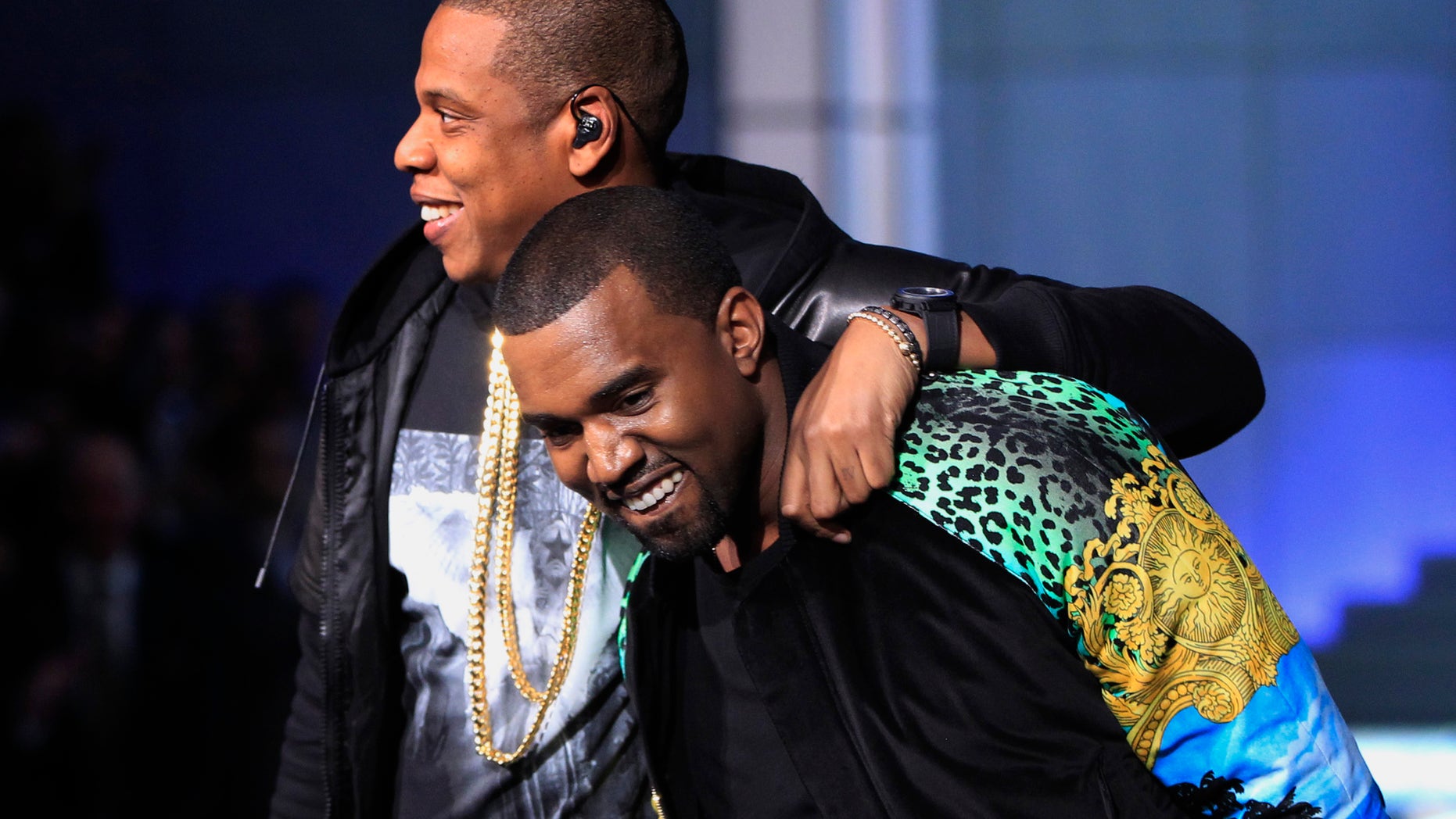 November 9, 2011. Rappers Jay-Z (L) puts his arm around Kanye West as they walk off stage after performing during the Victoria's Secret Fashion Show at the Lexington Armory in New York.