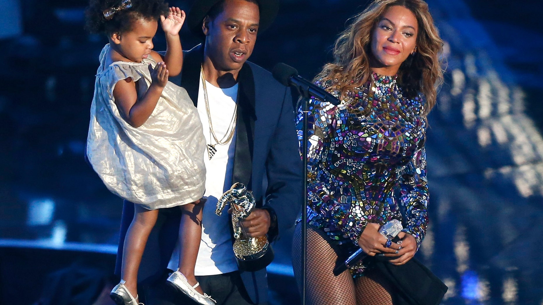 August 24, 2014. Jay-Z presents the Video Vanguard Award to Beyonce as he holds their daughter Blue Ivy during the 2014 MTV Video Music Awards in Inglewood, California.