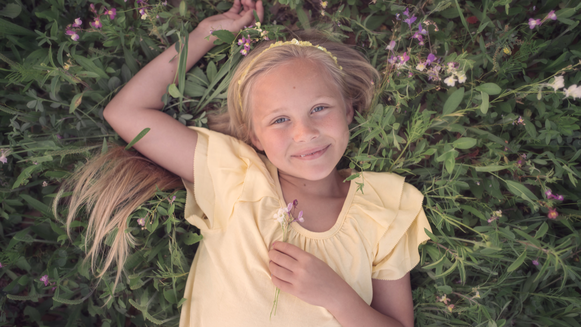 Lily Faith laying in the grass.
