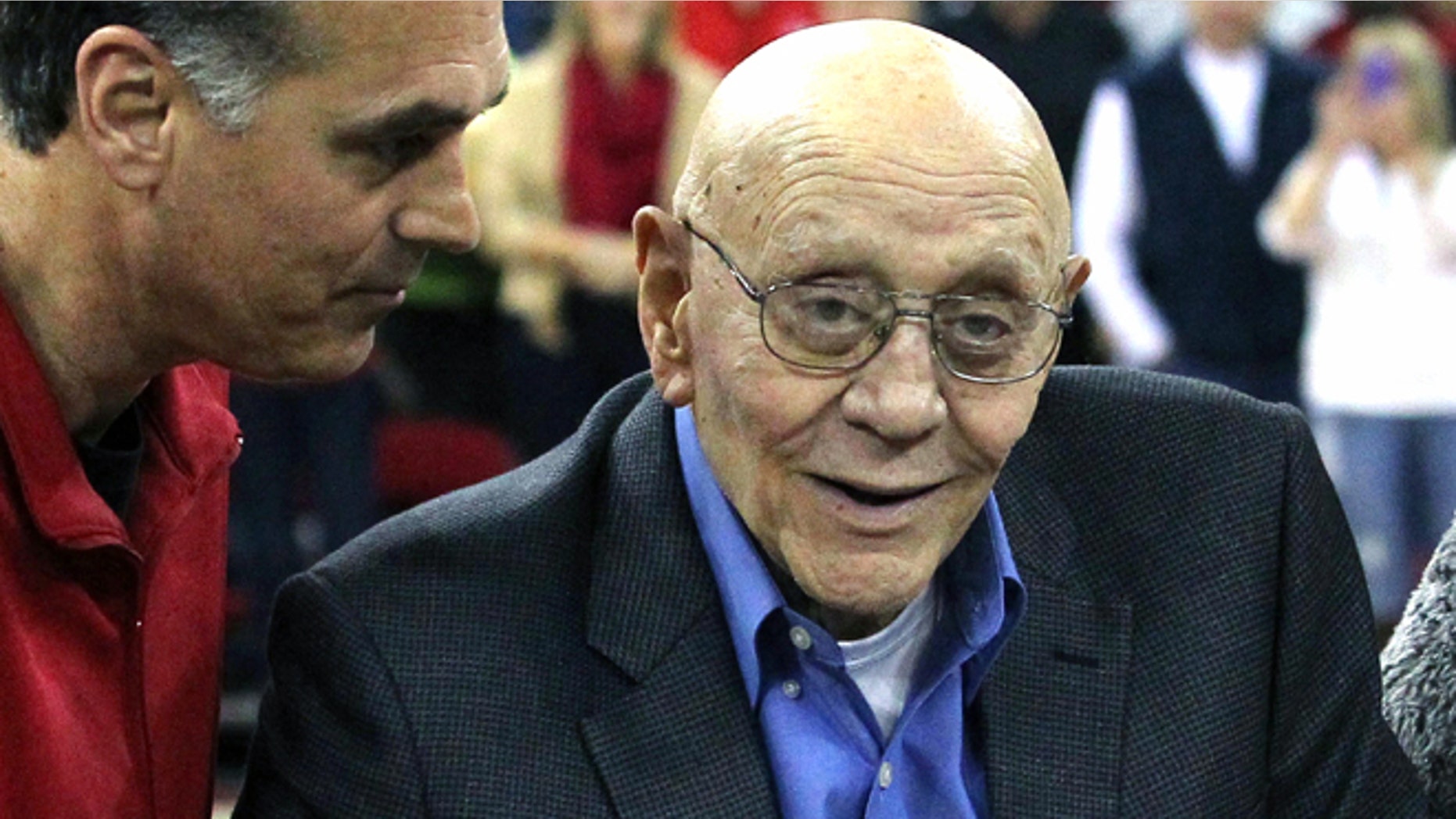 In this March 1, 2014, file photo, Jerry Tarkanian is escorted by his son, Danny, during halftime ceremonies honoring the former basketball coach at Fresno State University in Fresno, Calif.