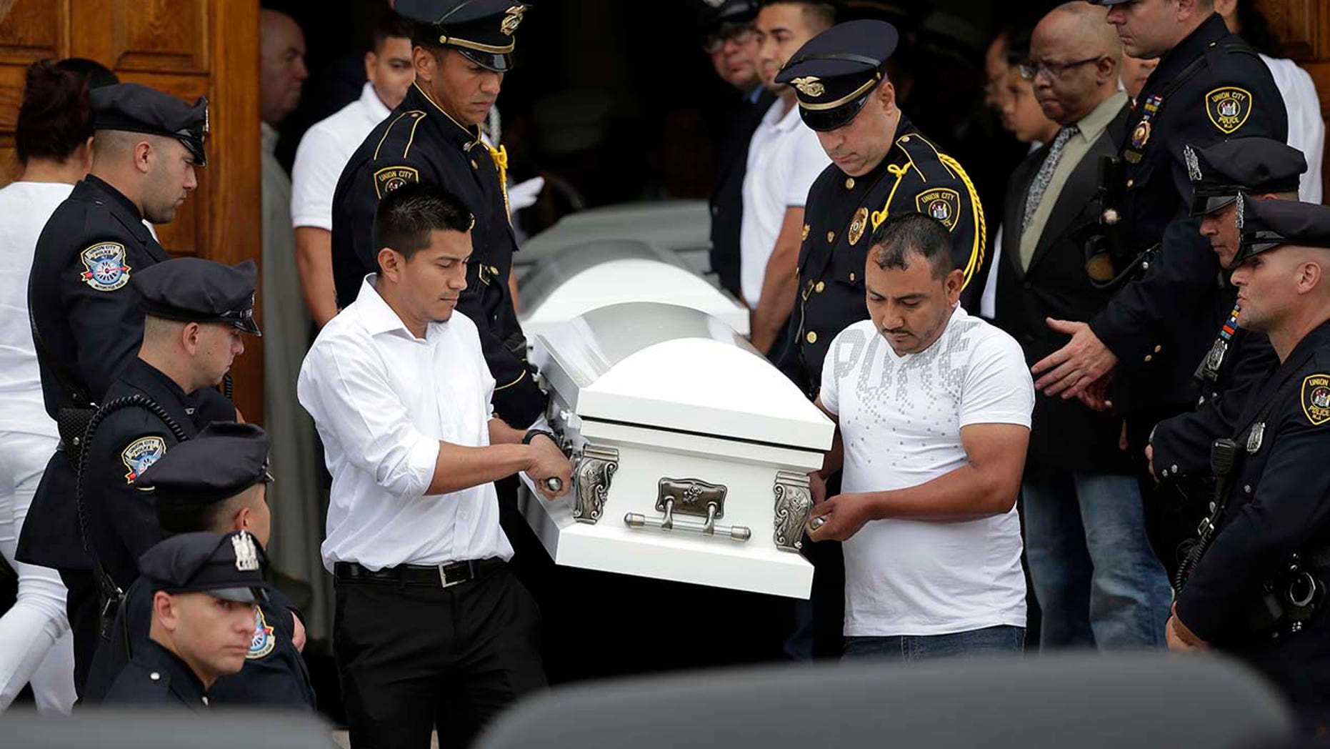 Five caskets are carried out of the church during a funeral for five children in Union City, N.J., Wednesday, July 25, 2018.