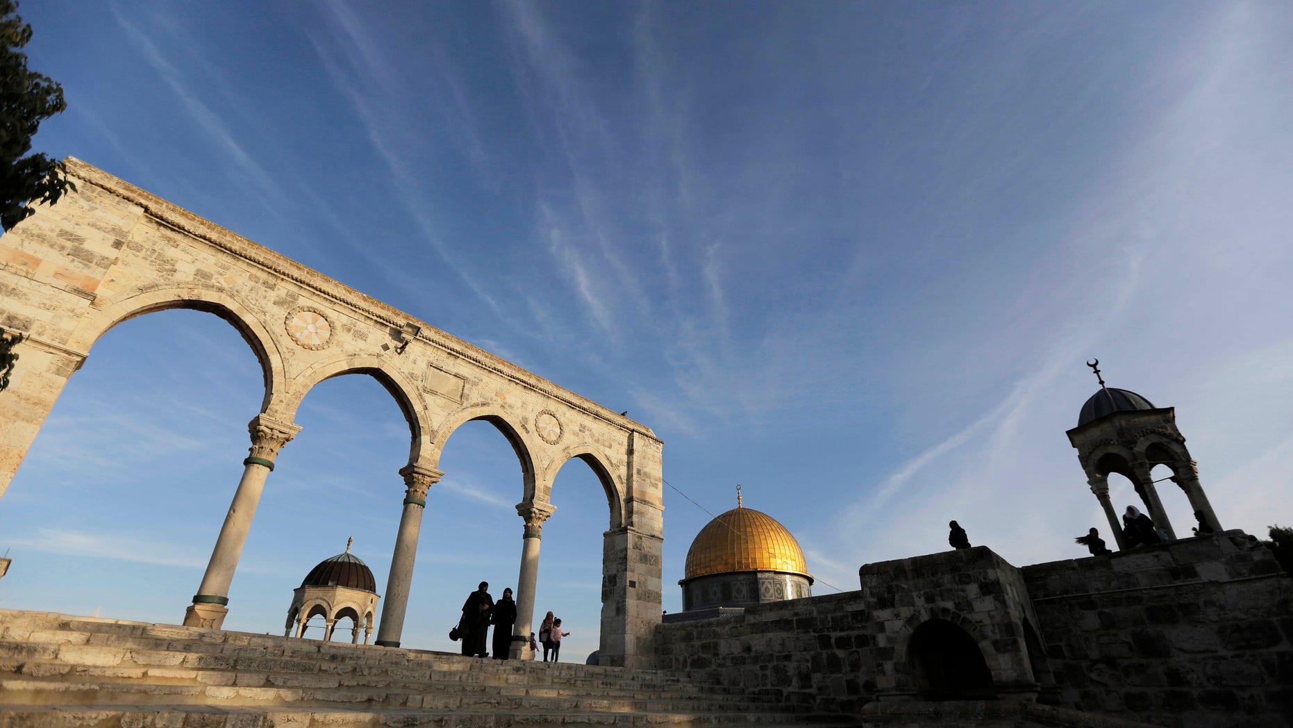 The Dome of the Rock (C) is seen in the background, as Palestinians visit the compound known to Muslims as Noble Sanctuary and to Jews as Temple Mount, in Jerusalem's Old City January 21, 2014. REUTERS/Ammar Awad (JERUSALEM - Tags: SOCIETY RELIGION TRAVEL TPX IMAGES OF THE DAY) - RTX17OCA