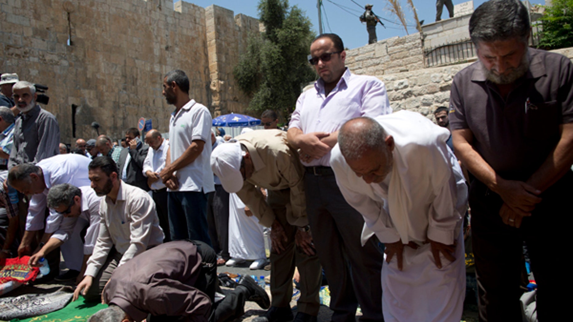 Palestinian Muslims pray outside Jerusalem's Lion's Gate following an appeal from clerics to pray in the streets instead of the Al Aqsa Mosque compound.A dispute over metal detectors has escalated into a new showdown between Israel and the Muslim world over the contested shrine that has been at the center of violent confrontations in the past.