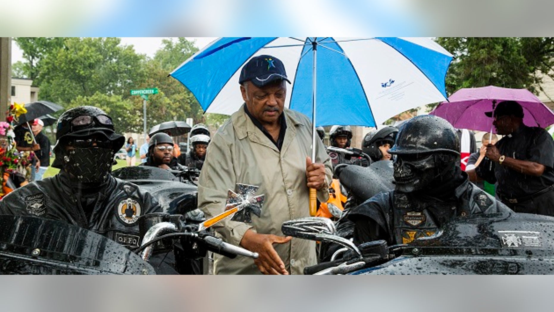 Civil rights leader Jesse Jackson (C) greets members of the "Outcast" motorcycle club before a vigil in the neighborhood where teenager Michael Brown was shot, in Ferguson, Missouri, August 16, 2014. Tensions had temporarily cooled on Thursday night but by Friday evening, protesters were again swarming through a residential and retail district in the small town outside St. Louis that has become the site of repeated clashes between protestors and police forces. The unrest erupted after Ferguson police officer Darren Wilson, 28, shot and killed Brown shortly after noon last Saturday as Brown and a friend walked down a street that runs through an apartment complex where Brown's grandmother lives. REUTERS/Lucas Jackson (UNITED STATES - Tags: CIVIL UNREST CRIME LAW TPX IMAGES OF THE DAY) - RTR42O0M