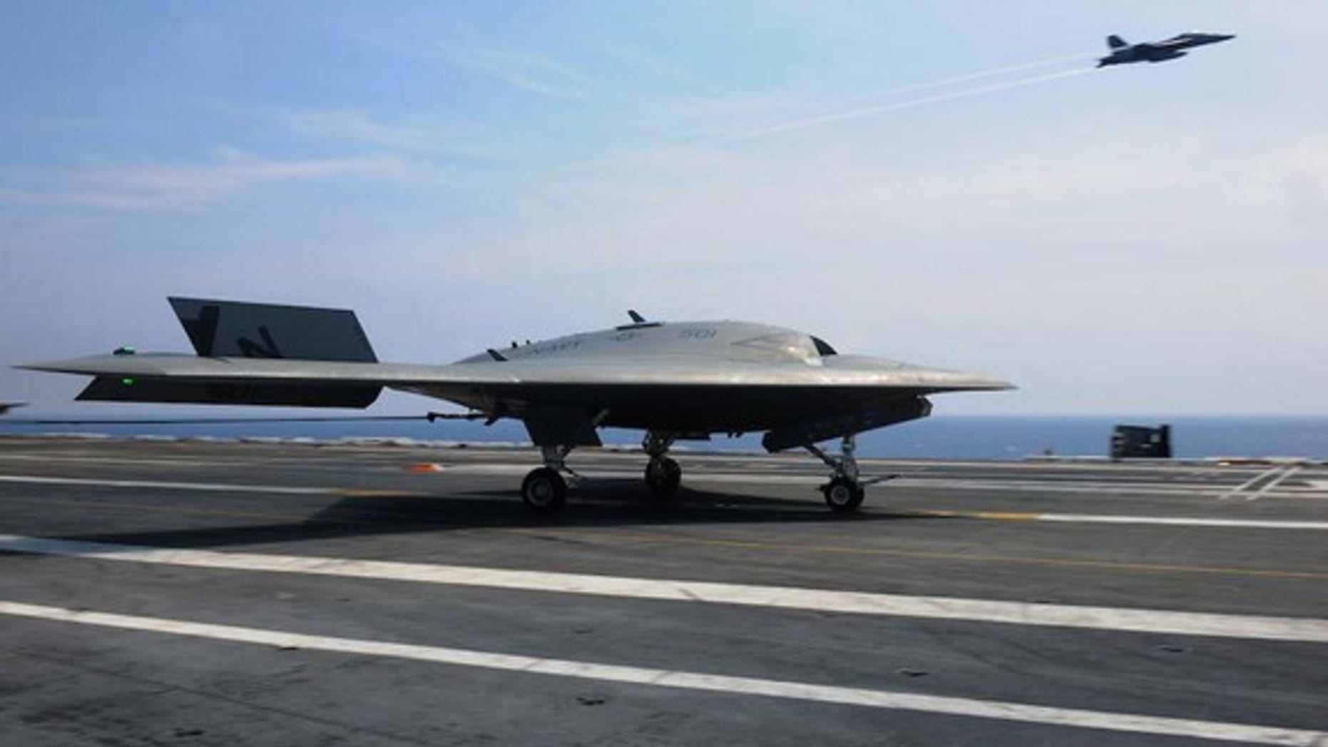 The U.S. Navy's unmanned X-47B lands aboard the USS Theodore Roosevelt.