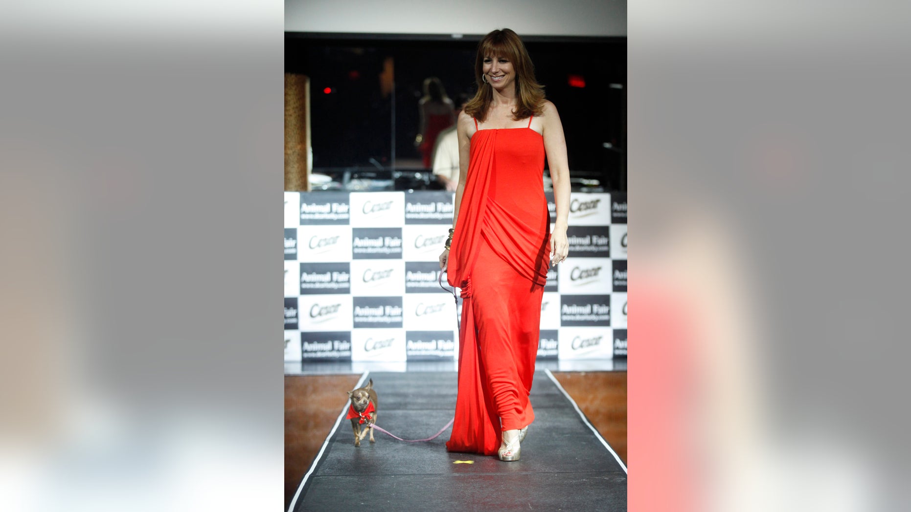 July 27, 2009. Reality television personality Jill Zarin walks on the runway with her dog Darren during the "Paws for Style" dog fashion show in New York.