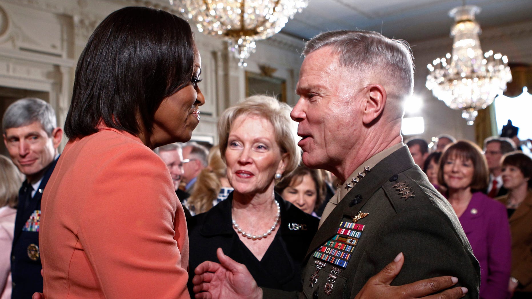 April 12, 2011: U.S. first lady Michelle Obama (L) talks with General James Amos (R) in the East Room at the White House.