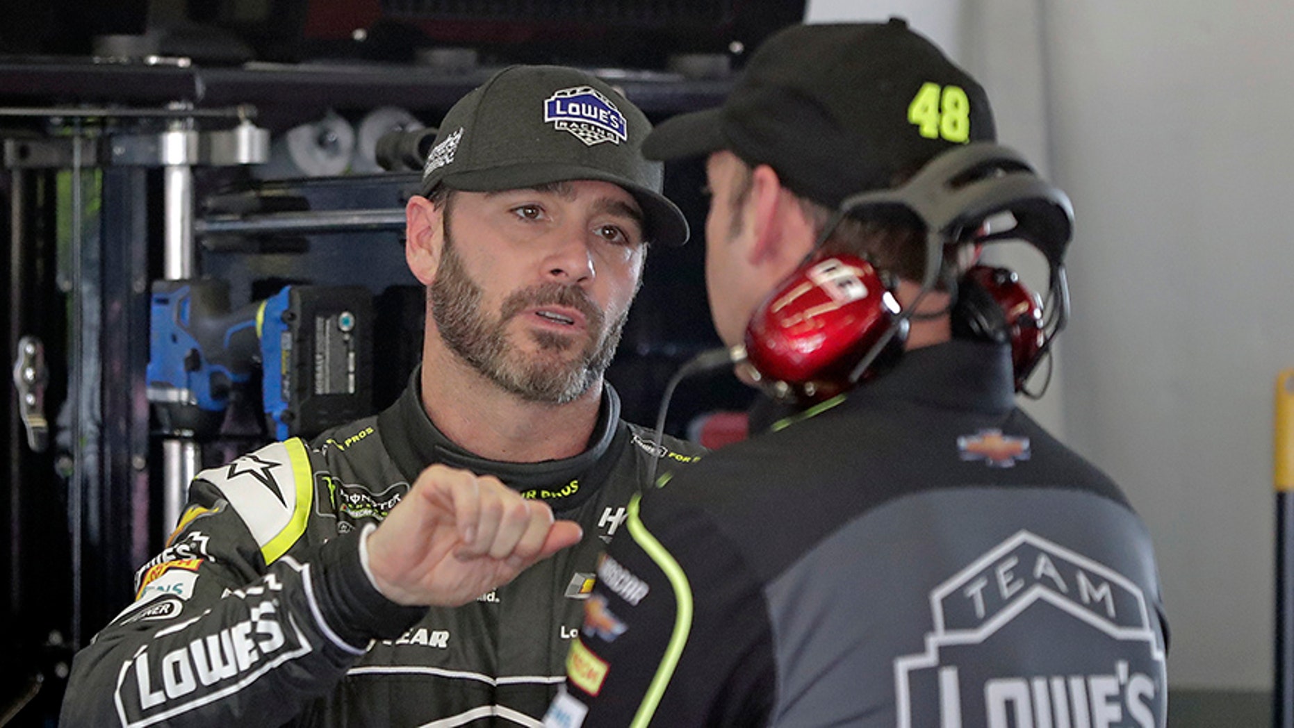 Jimmie Johnson talks with crew chief Chad Knaus during practice for the Daytona 500.