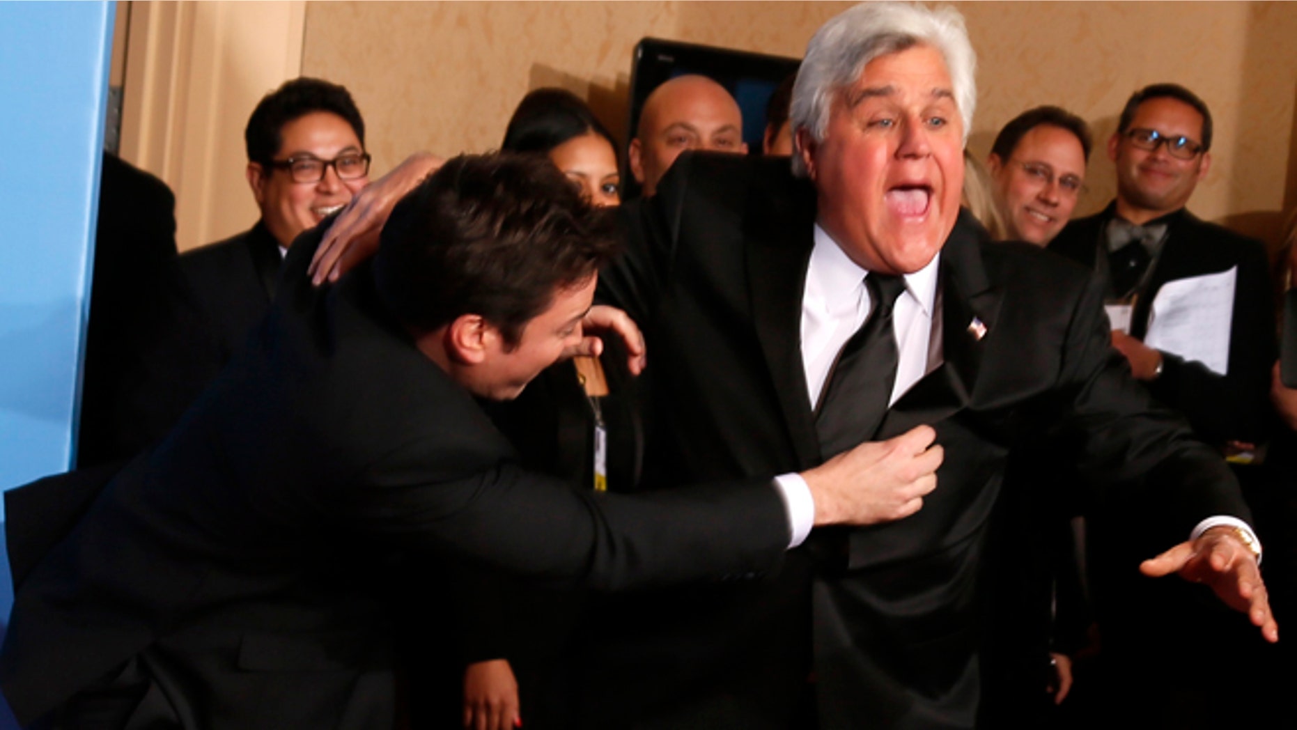 Late night talk show hosts Jimmy Fallon (L) and Jay Leno joke around backstage at the 70th annual Golden Globe Awards in Beverly Hills, California, January 13, 2013.