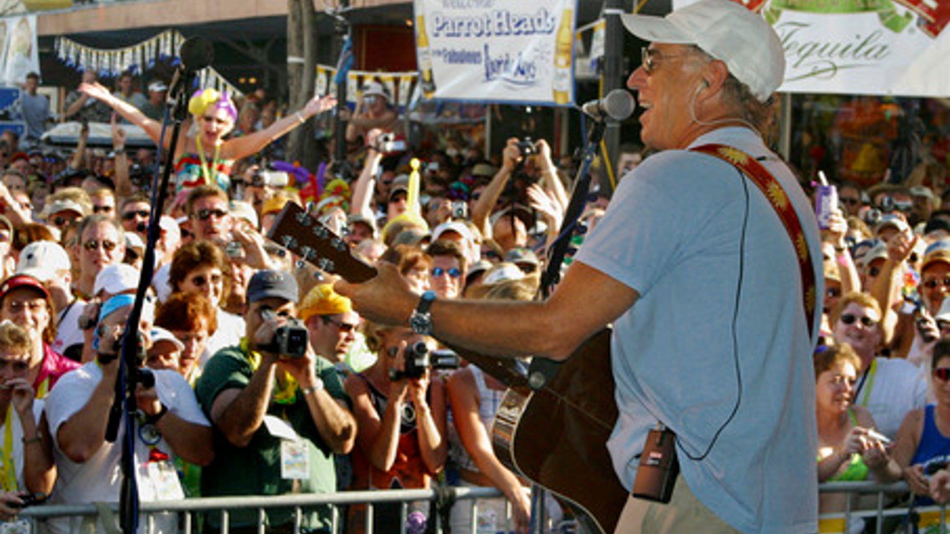Singer Jimmy Buffett makes a surprise appearance at the annual Parrot Heads in Paradise convention in Key West, Fla., Friday Nov. 1, 2002. More than 3,000 of the singer's fans have gathered in Key West through Sunday, Nov. 3. There are now almost 160 Parrot Head chapters in the U.S., Australia and Canada with more than 18,000 total members. (AP Photo/Florida Keys News Bureau, Roberto Rodriguez)