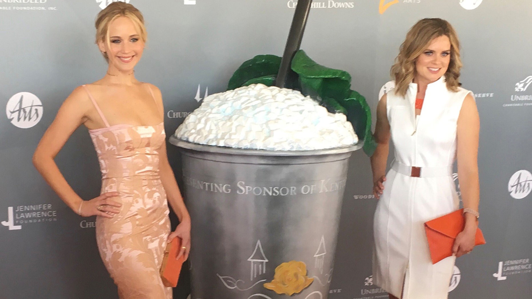 Jennifer Lawrence attended an event for the Kentucky Derby in a pizza-stained dress with with Woodford Reserve’s Assistant Master Distiller, Elizabeth McCall.