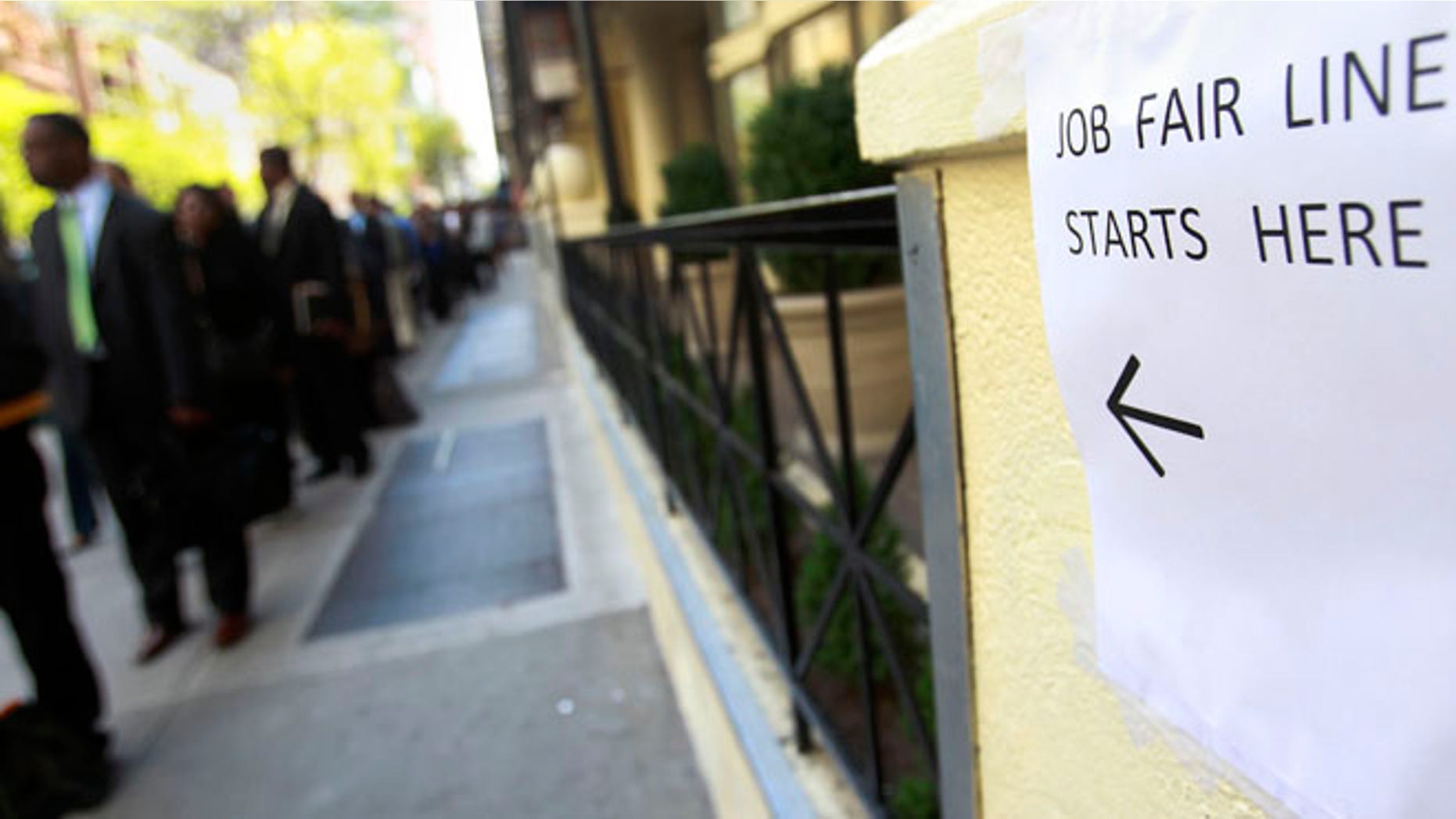 April 18, 2012: People wait in line to enter a job fair in New York.