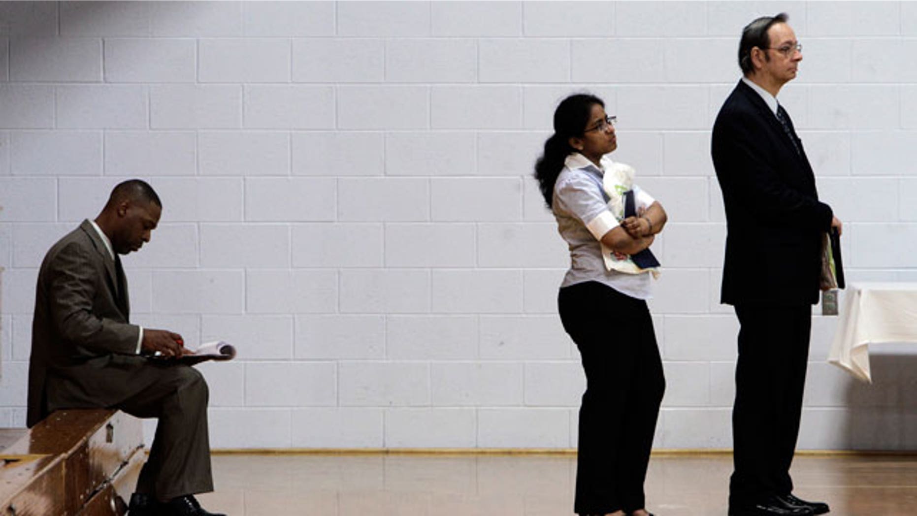 Job seekers wait in a line at a job fair in Southfield, Mich., Wednesday, June 15, 2011.