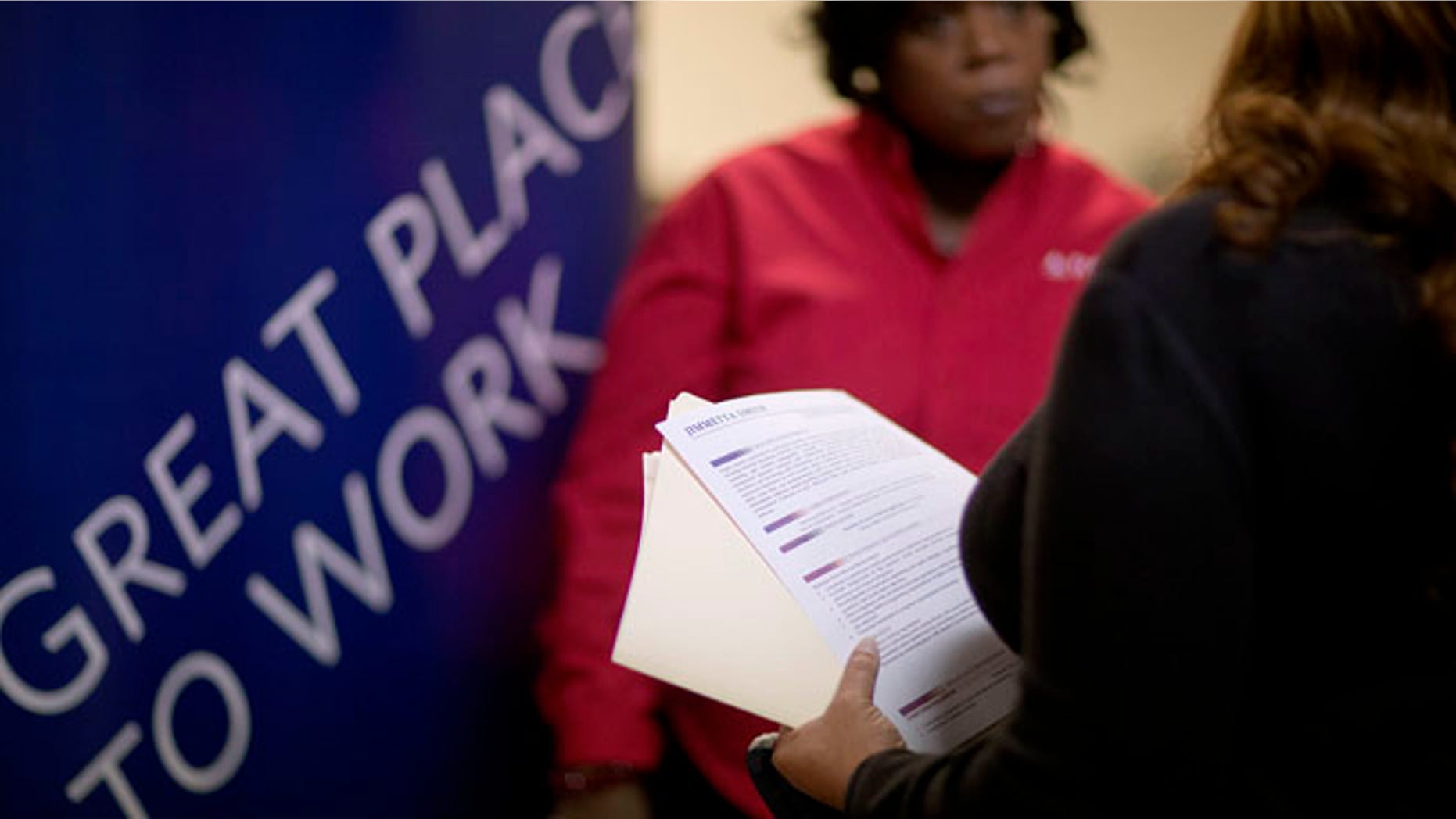 Nov. 14, 2013: A woman holds her resume while talking with a senior recruiter for Delta airlines at a job fair for veterans and family members in Marietta, Ga.