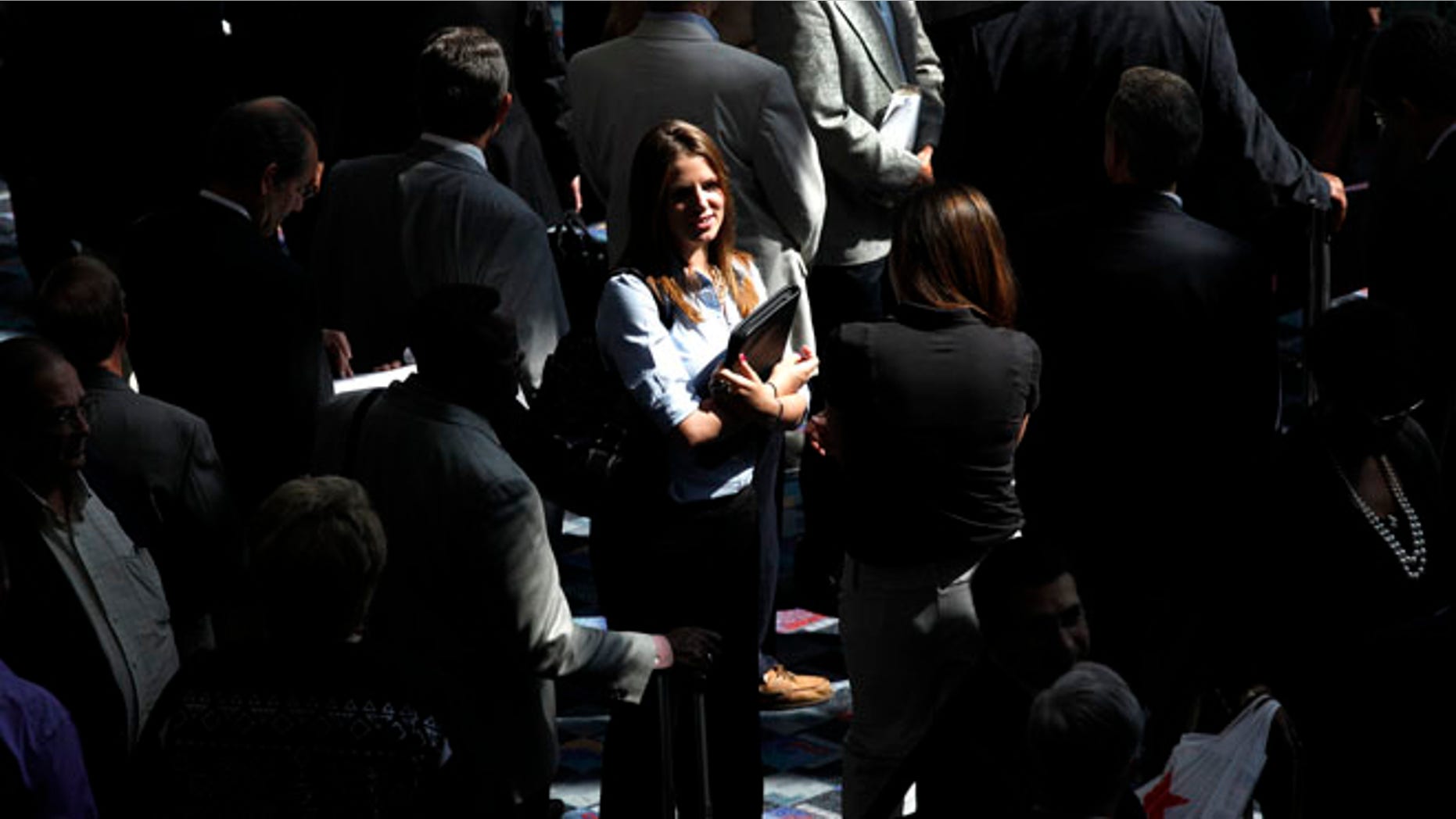 June 26, 2012: A Florida woman stands in line at a job fair in Detroit.