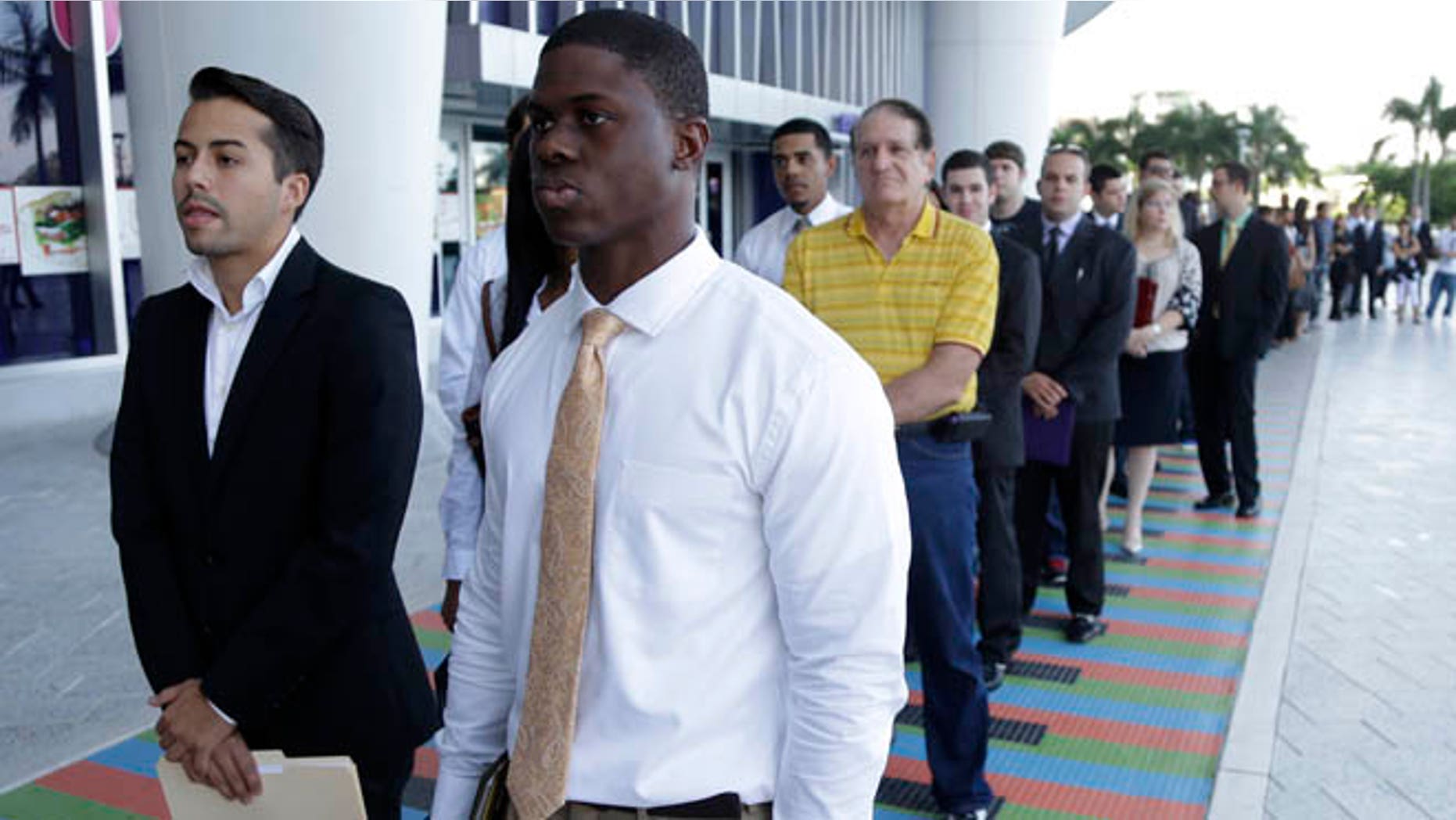 Oct. 23, 2013: College students wait in line at a job fair held by the Miami Marlins, at Marlins Park in Miami.