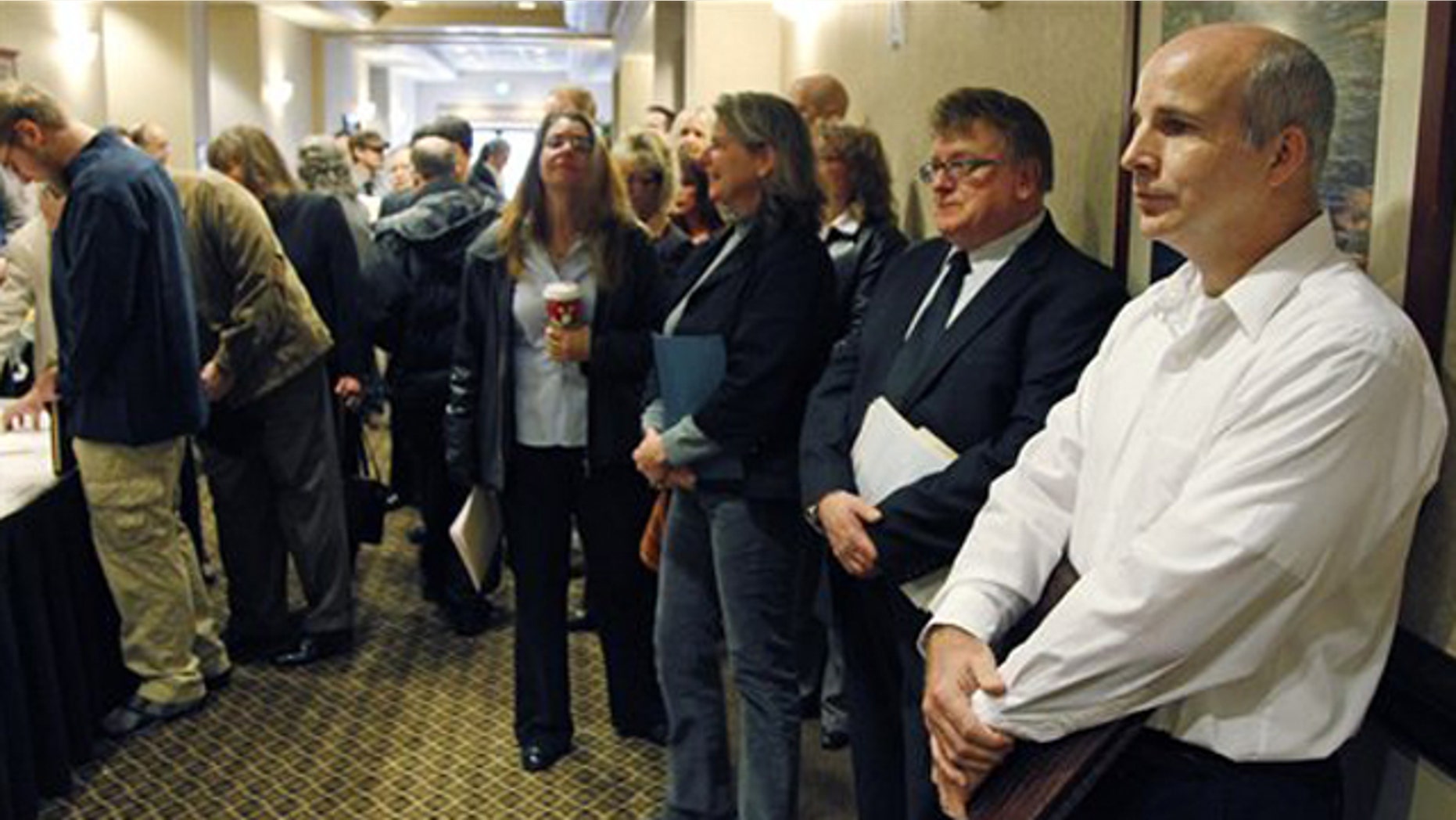 Dec. 2, 2011: People wait in line to enter a job fair in Portland, Ore.