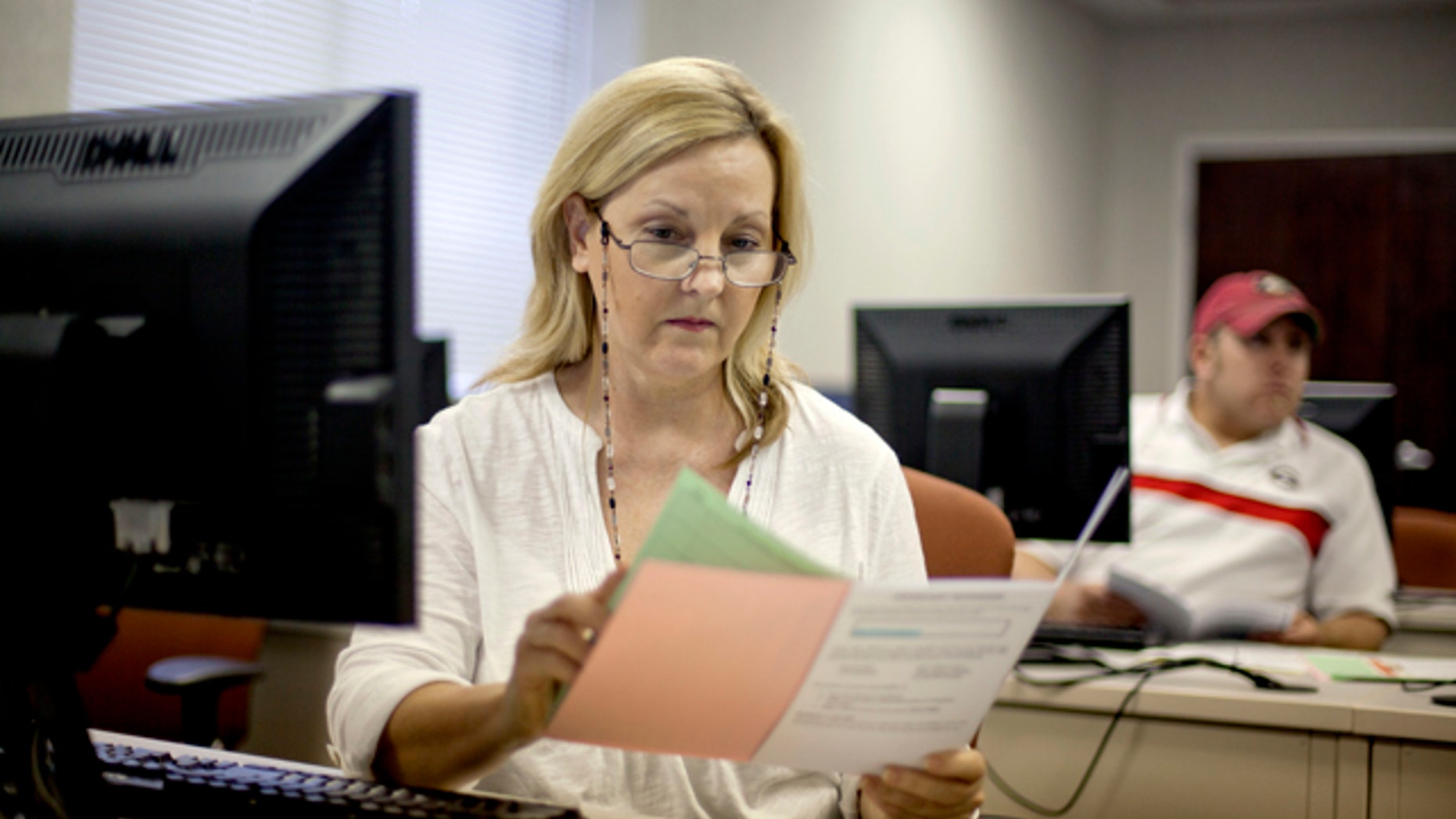 Aug. 22, 2012: Judy Smith, of Dalton, Ga., looks over paperwork as she files for unemployment for the first time since being laid off from a catering job at a convention center in Dalton, Ga. (AP)