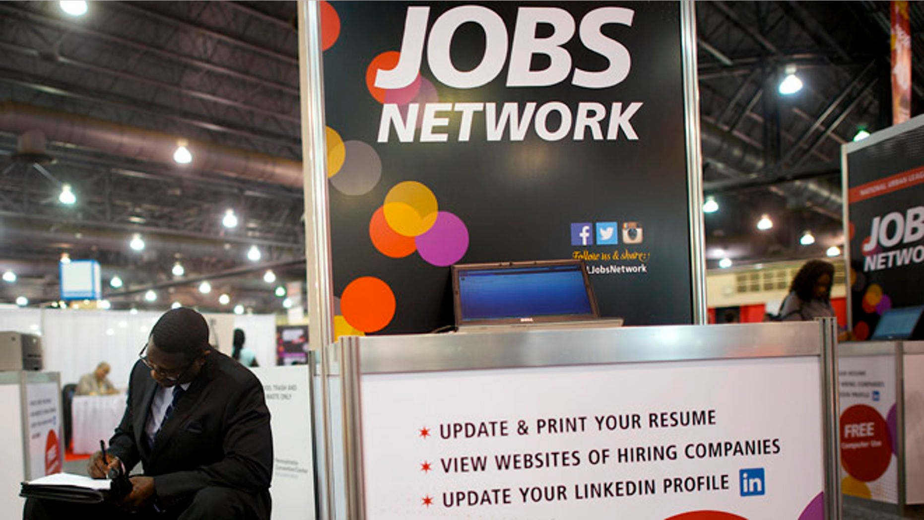 July 25, 2013: A job-seeker completes an application at a career fair held by civil rights organization National Urban League as part of its annual conference, in Philadelphia.