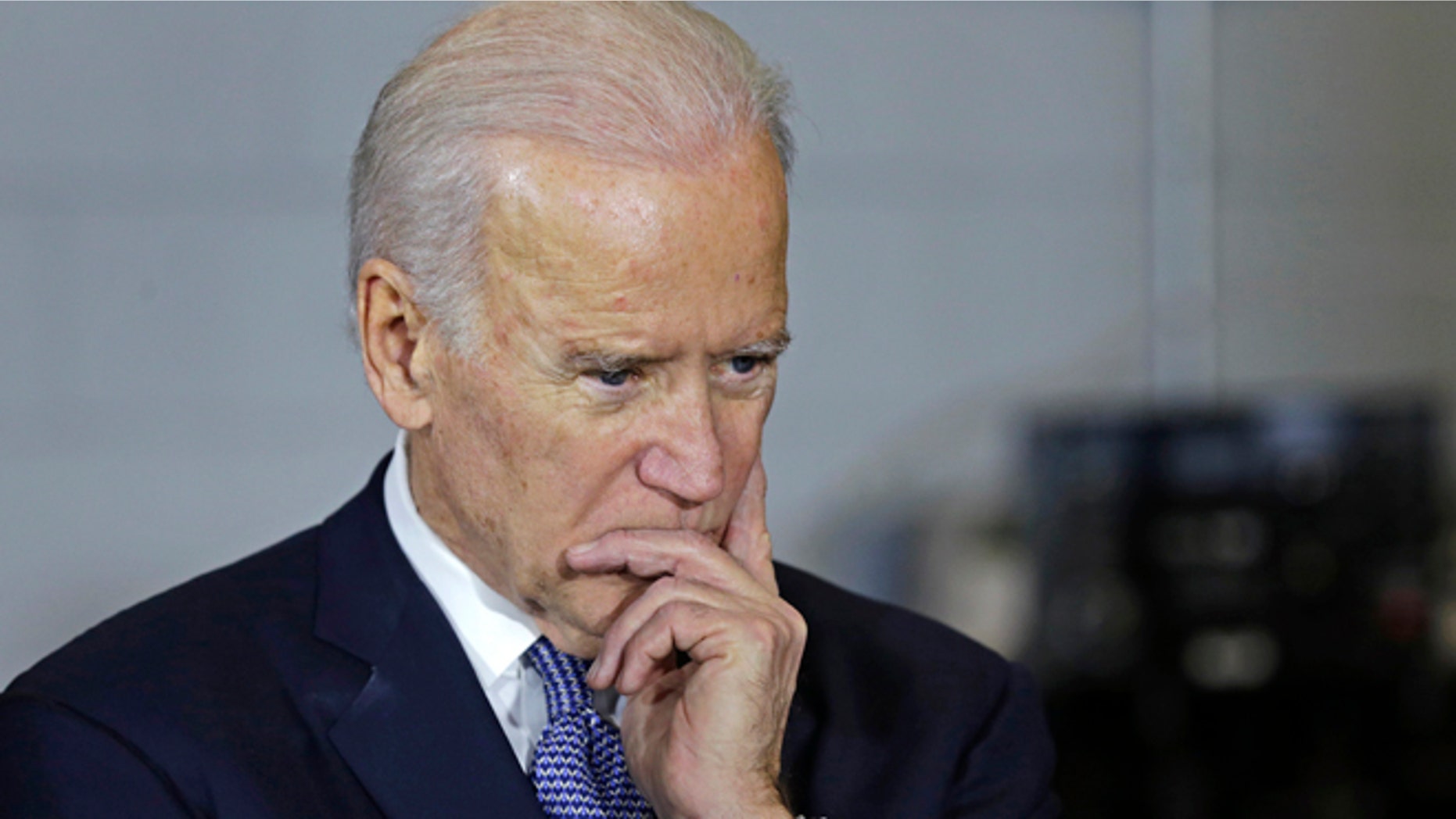 Feb. 25, 2015: Vice President Joe Biden listens to a student during a visit to robotic welding shop at the Manchester Community College in Manchester, N.H.
