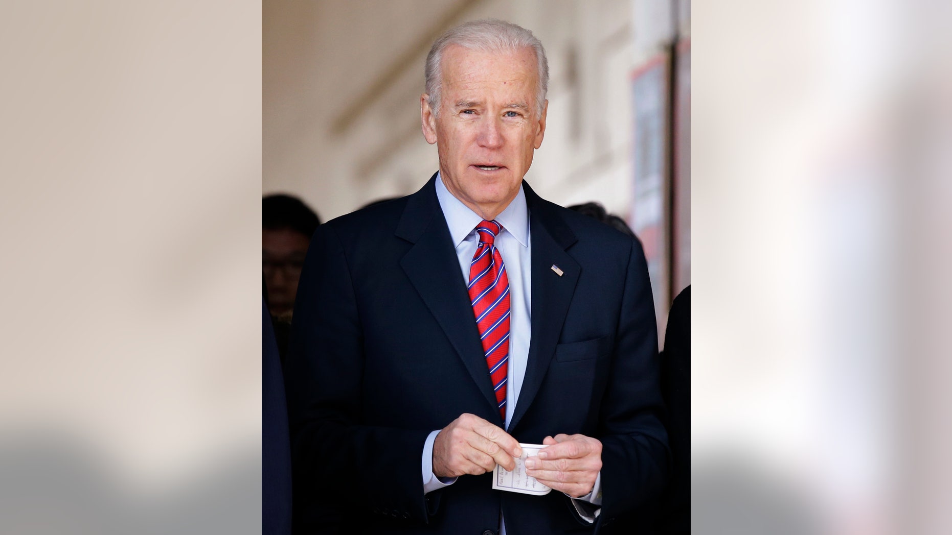 U.S. Vice President Joe Biden leaves after laying a wreath in front of the list of names of U.S. soldiers who died during the 1950-53 Korean War, at the Korean War Memorial Museum in Seoul, Dec. 7, 2013.