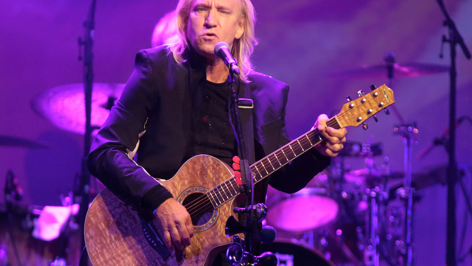 FILE - In this Oct. 12, 2015 file photo, Joe Walsh of the band The Eagles performs in a solo concert at The Fillmore in Philadelphia. Eagles keyboardist and guitarist Walsh says hes pulling out of a Cleveland summer concert he thought would be a nonpartisan event for veterans families because its actually a launch for the Republican National Convention. The concert is scheduled for July 18, 2016. (Photo by Owen Sweeney/Invision/AP, File)