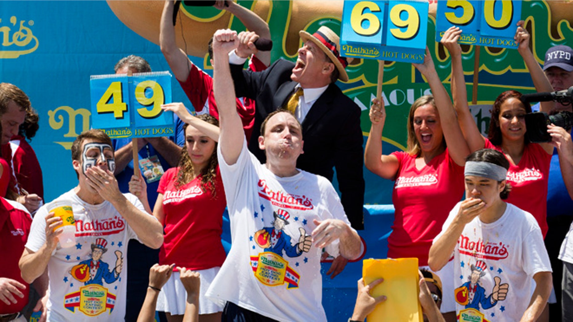 July 4, 2013: Joey Chestnut, center, wins the Nathan's Famous Fourth of July International Hot Dog Eating contest with a total of 69 hot dogs and buns, alongside Tim Janus, left, and Matt Stonie, right, at Coney Island, in the Brooklyn borough of New York.