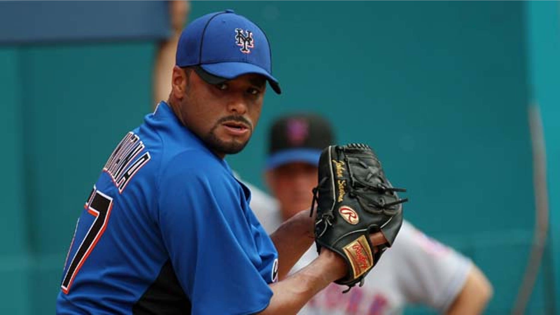July 24, 2011: Johan Santana #57 of the New York Mets pitches in the bullpen as Manager Terry Collins #10 looks on during a throwing session before a game against the Florida Marlins at Sun Life Stadium in Miami Gardens, Fla.
