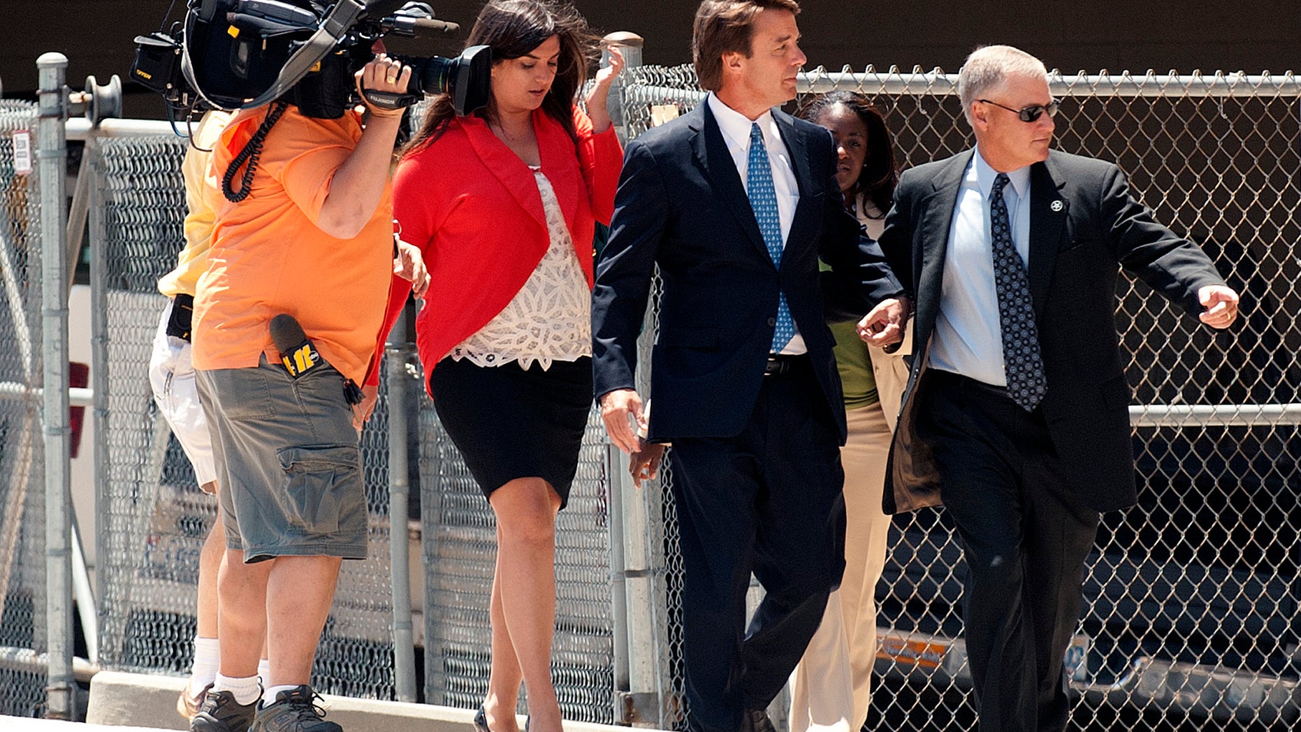 John Edwards, center, enters the Federal Building in downtown Winston-Salem, N.C. on Friday, June 3, 2011. (AP)