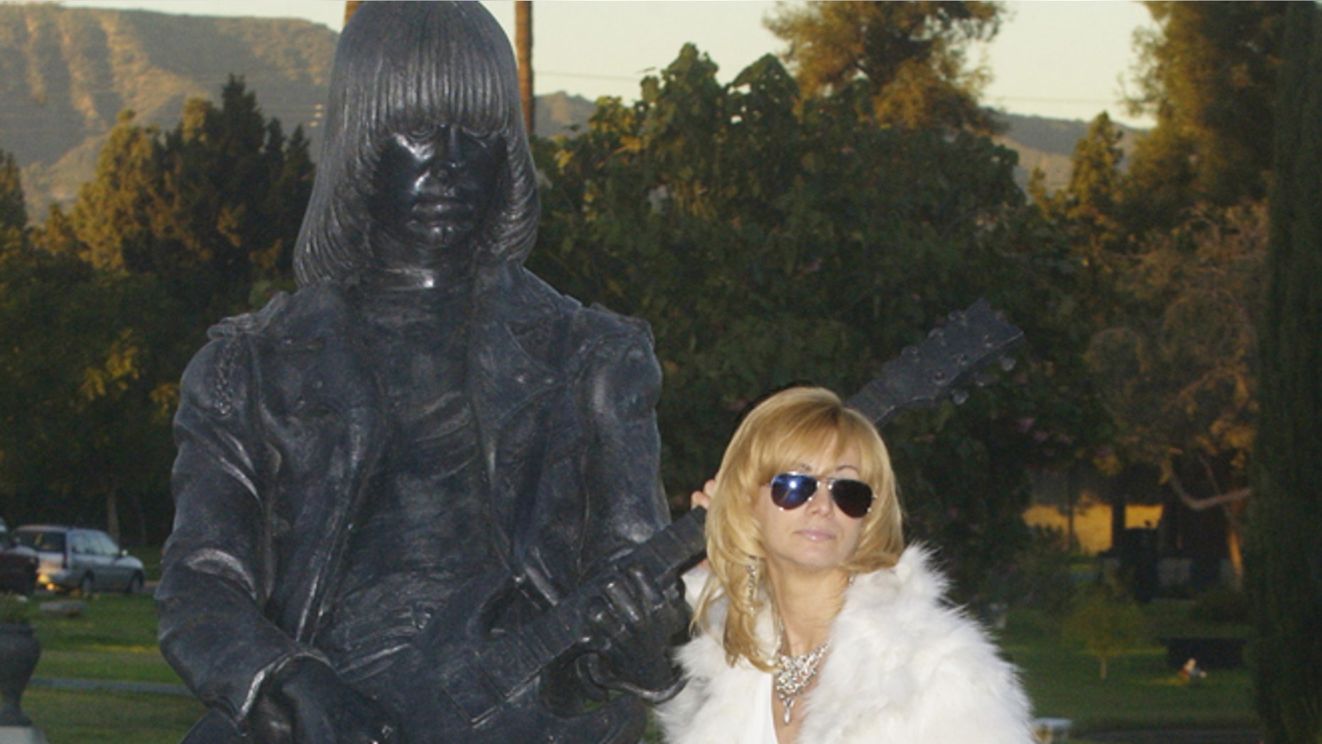 Linda Ramone, widow of Johnny Ramone poses next to a statue of his likeness in Los Angeles.