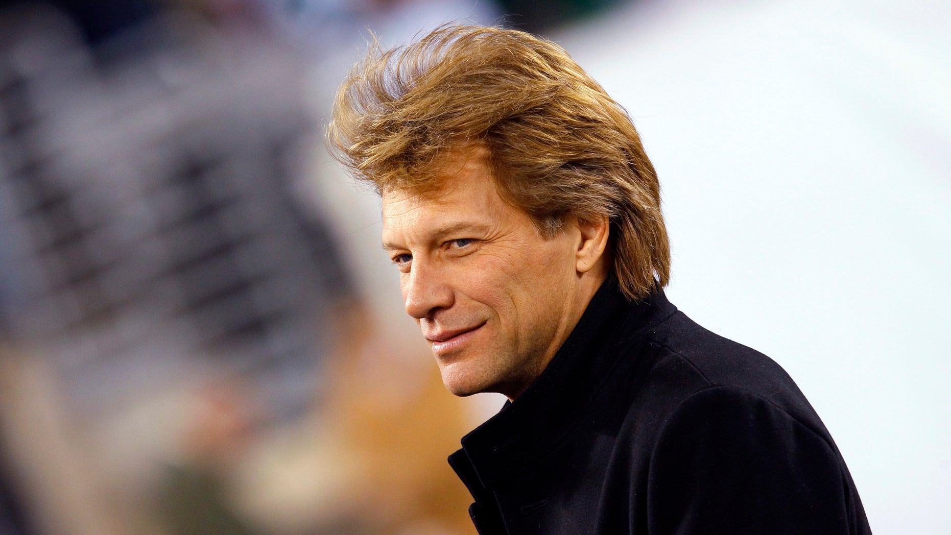 November 13, 2011. Musician Jon Bon Jovi walks on the field before the NFL football game between the New England Patriots and the New York Jets in East Rutherford, New Jersey.