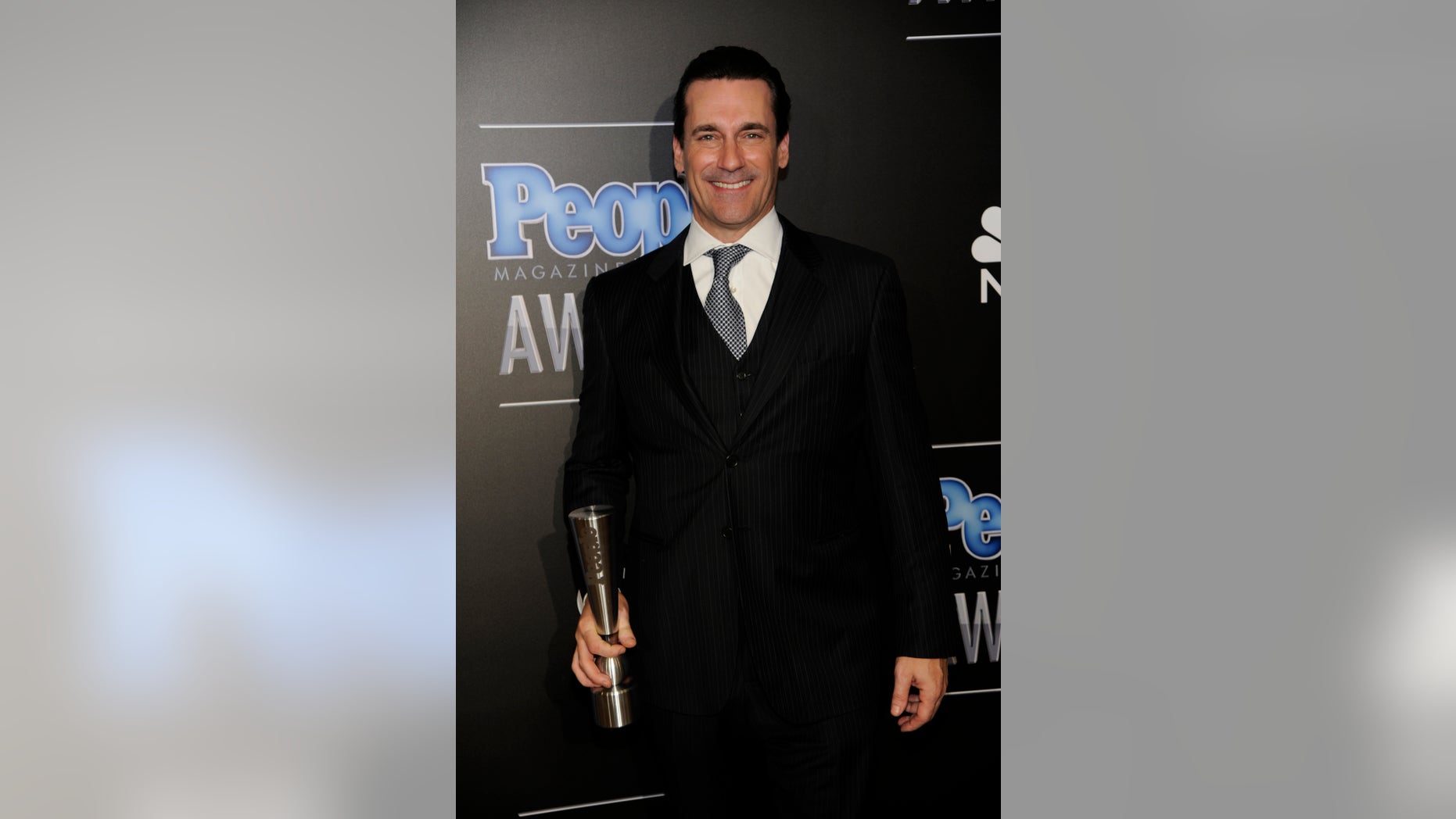 December 18, 2014. Jon Hamm poses backstage with the award for TV performance of the year - actor at The People Magazine Awards at the Beverly Hilton hotel in Beverly Hills, California.