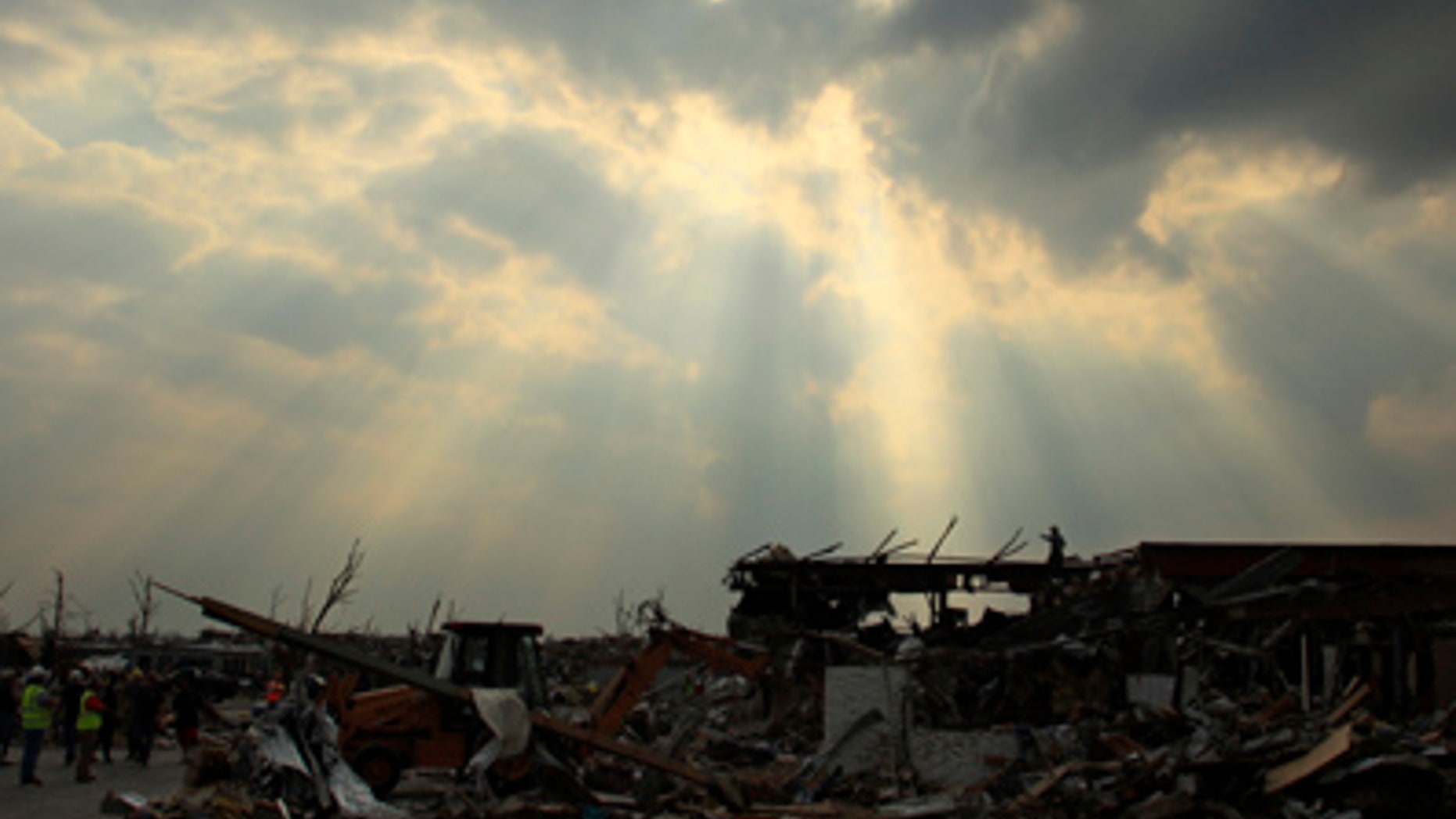 May 28: A search and rescue team surveys the area from atop the rubble of a destroyed building in Joplin, Mo. An EF-5 tornado tore through much of the city Sunday, damaging a hospital and hundreds of homes and businesses and killing at least 139 people. (AP)