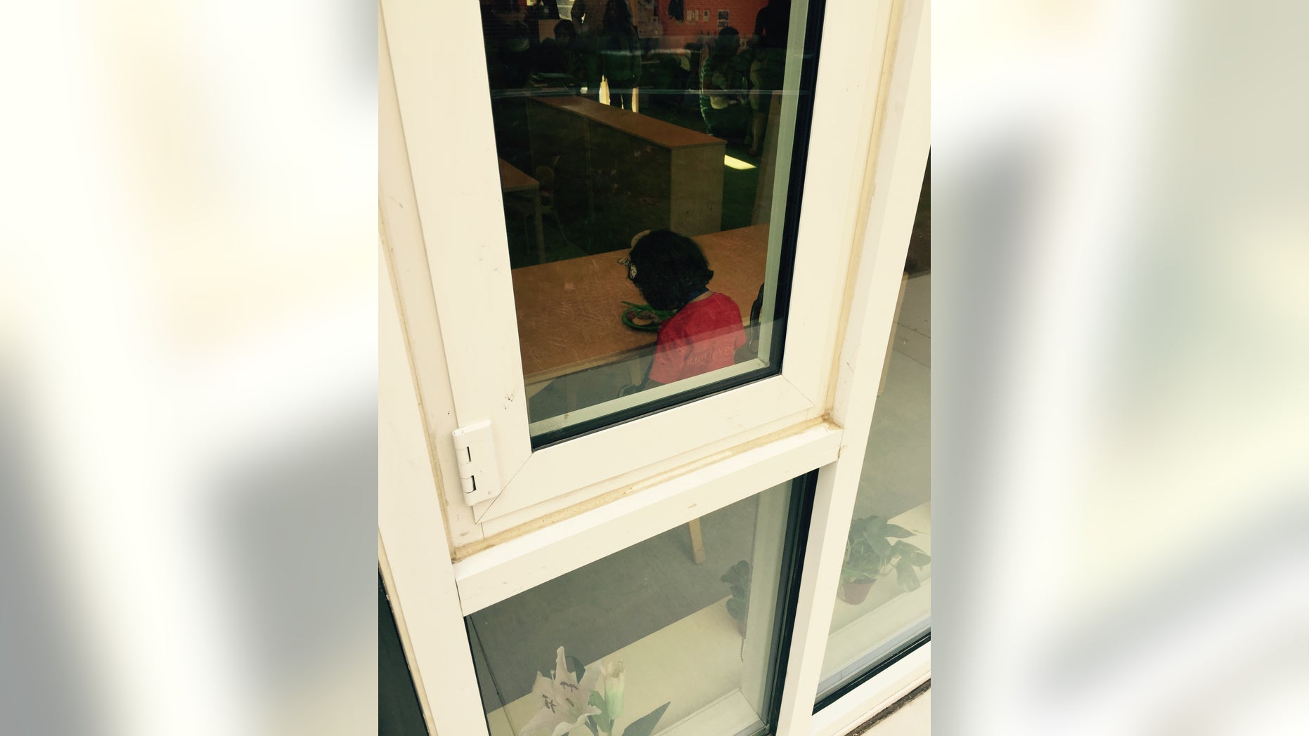 The author's daughter, sitting with her head down in the classroom, moments after he said goodbye to her. (Courtesy of Joshua Rogers)