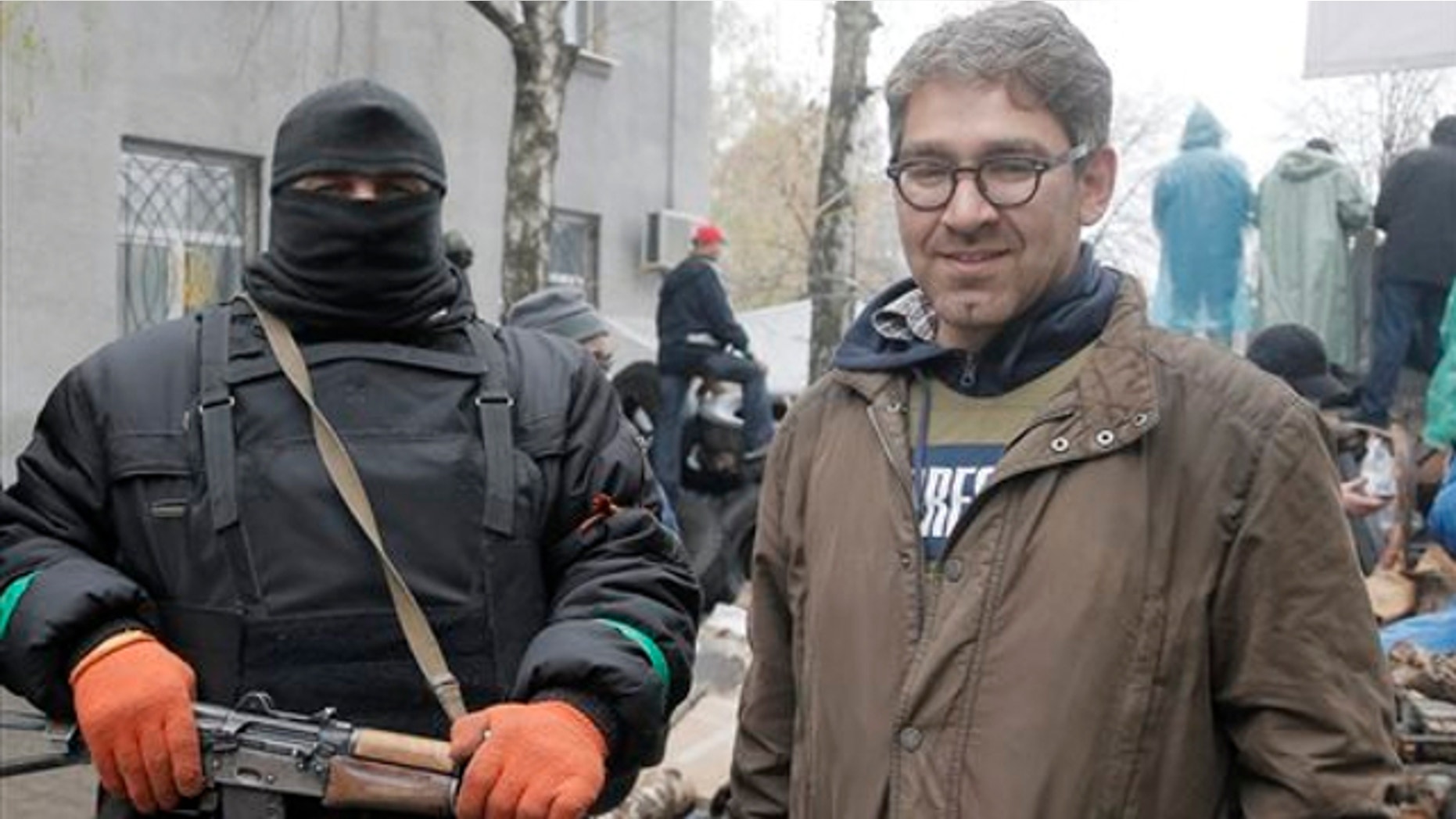 April 13, 2014: A reporter Simon Ostrovsky, right, stands next to a Pro-Russian gunman at a seized police station in the eastern Ukraine town of Slovyansk.