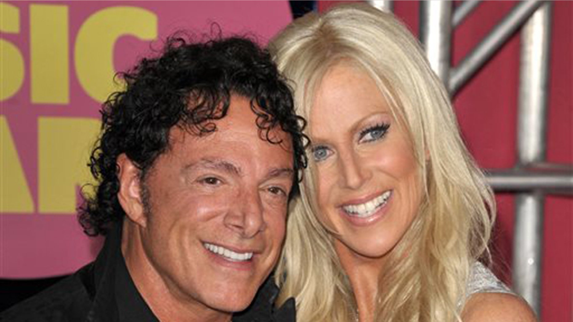 June 6, 2012: In this file photo, Neal Schon, left, and Michaele Salahi arrive at the CMT Music Awards in Nashville, Tenn.