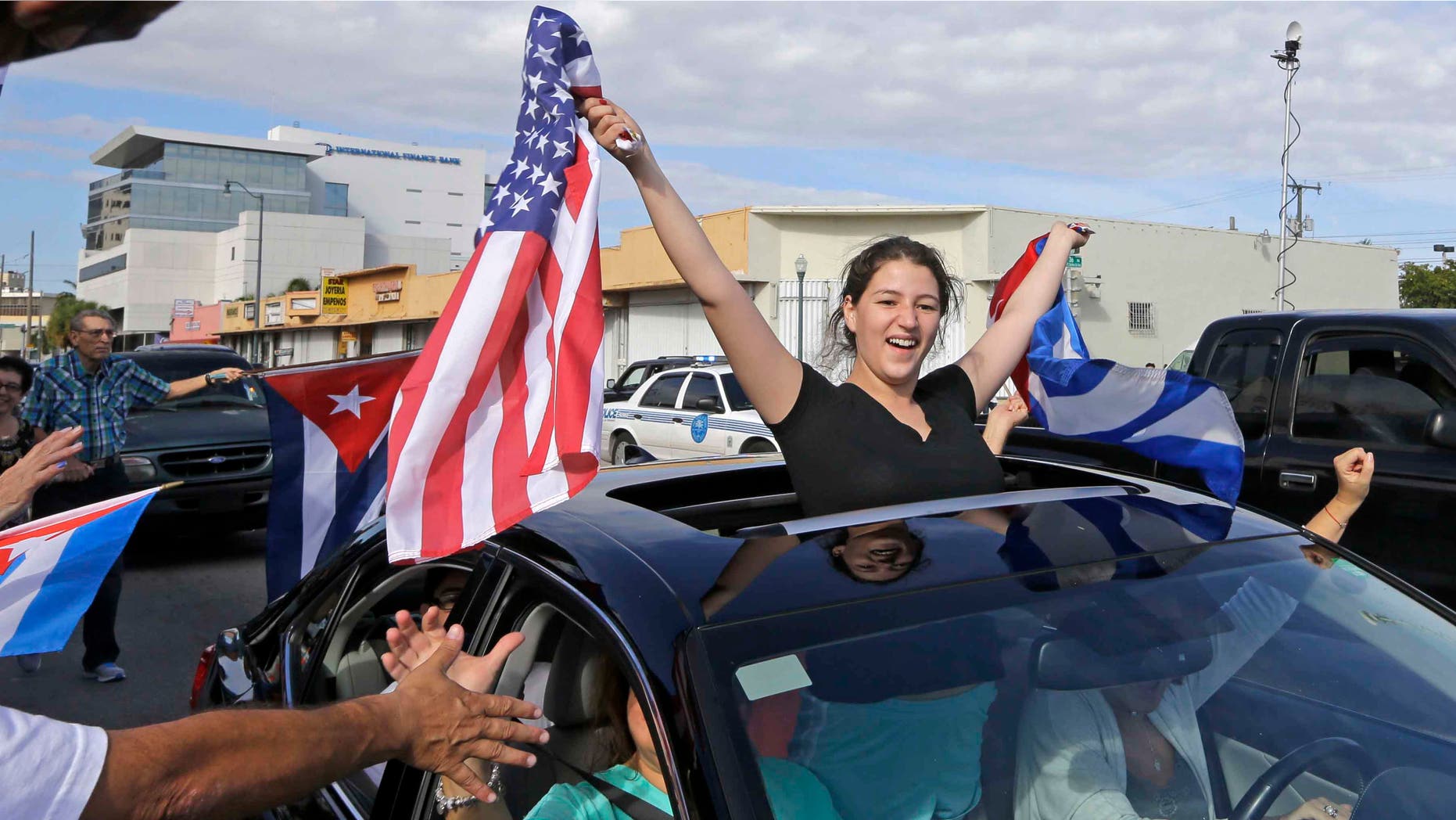 Cuban-Americans react to the death of Fidel Castro, Saturday, Nov. 26, 2016, in the Little Havana area in Miami.