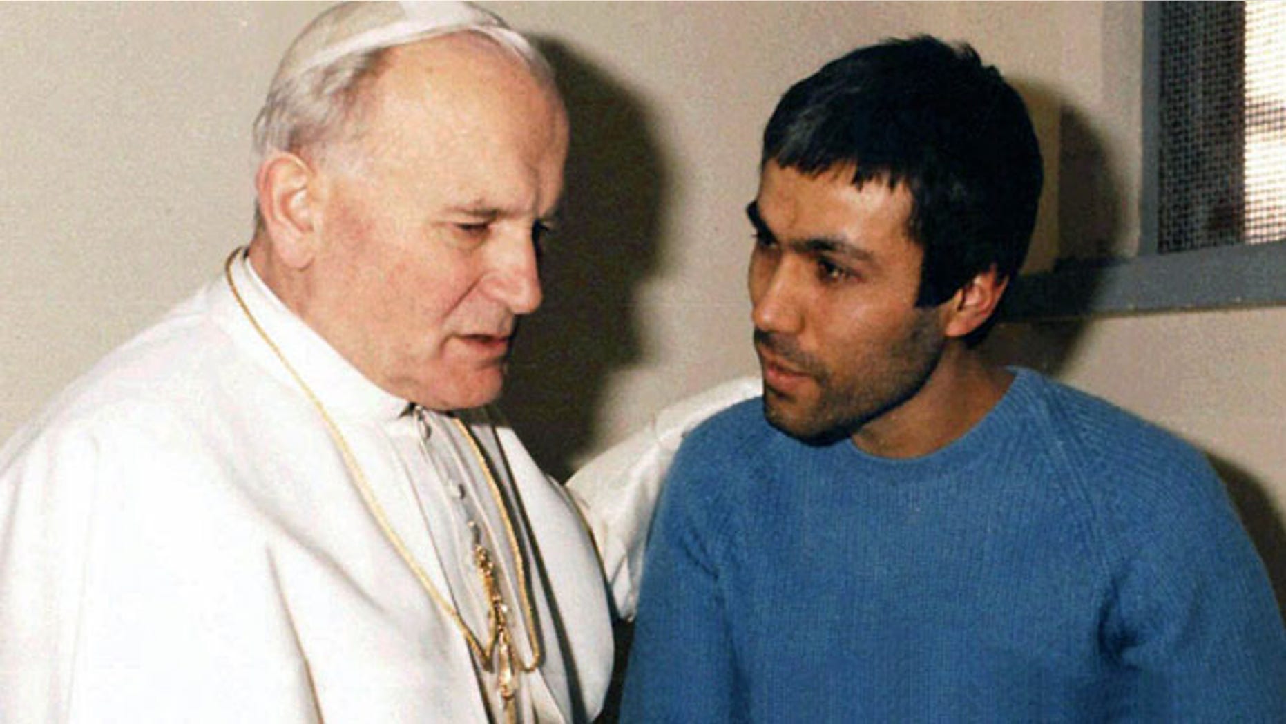 Dec. 27, 1983: In this file photo provided by Vatican newspaper L'Osservatore Romano, Pope John Paul II, left, meets Mehmet Ali Agca, in Agca's prison cell in Rome. (AP)