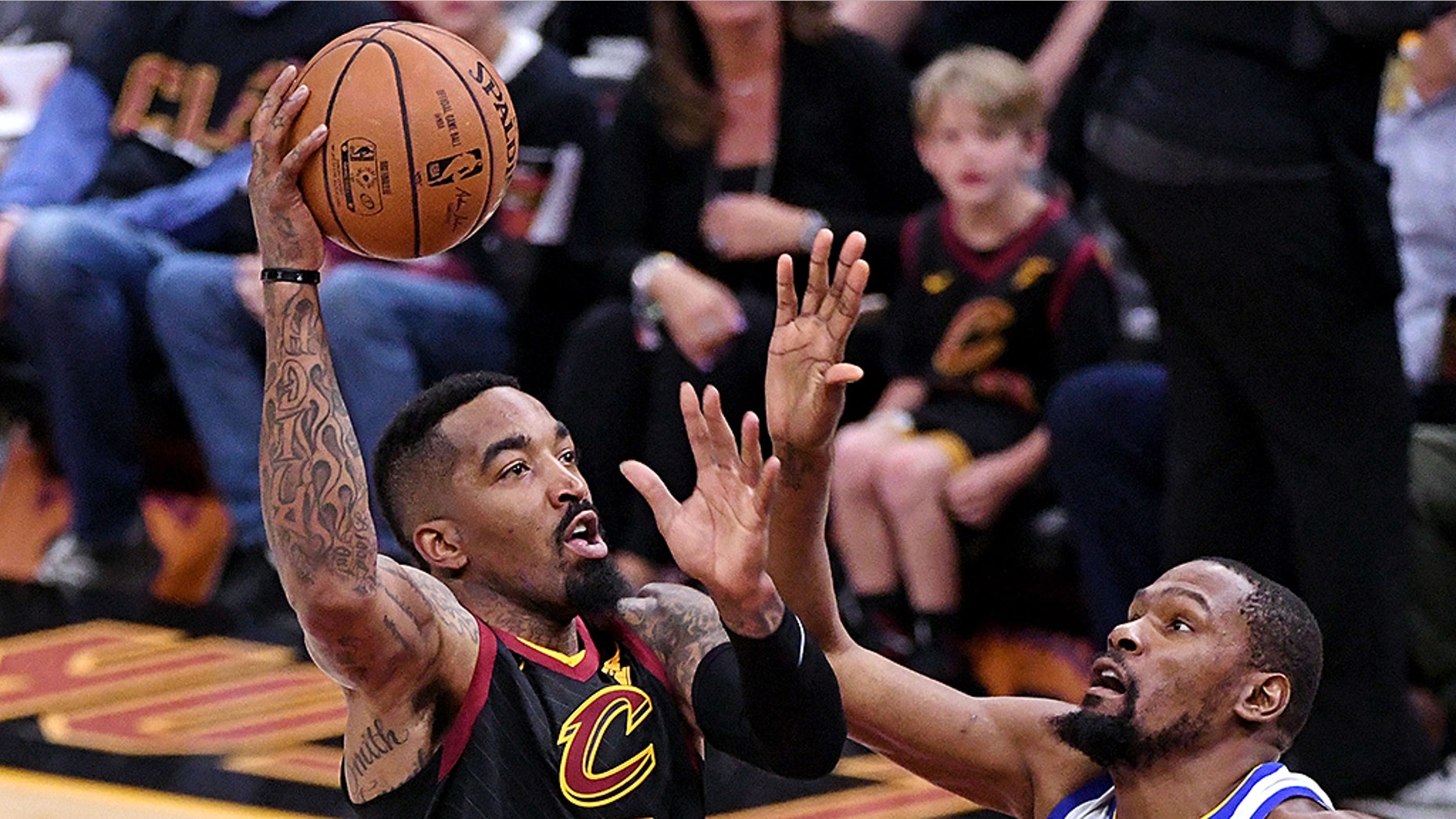 Cleveland Cavaliers guard JR Smith (5) shoots the ball against Golden State Warriors forward Kevin Durant (35) during the first quarter in game three of the 2018 NBA Finals at Quicken Loans Arena.
