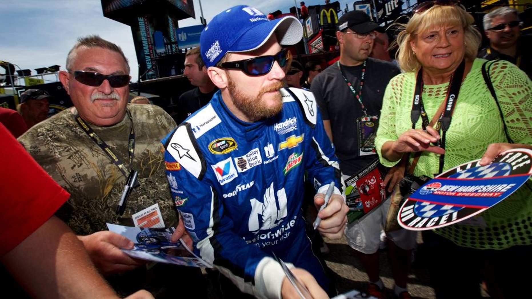 LOUDON, NH - JULY 17: Dale Earnhardt Jr., driver of the #88 Nationwide Chevrolet, signs autographs for fans during practice for the NASCAR Sprint Cup Series 5-Hour Energy 301 at New Hampshire Motor Speedway on July 17, 2015 in Loudon, New Hampshire. (Photo by Nick Laham/Getty Images)