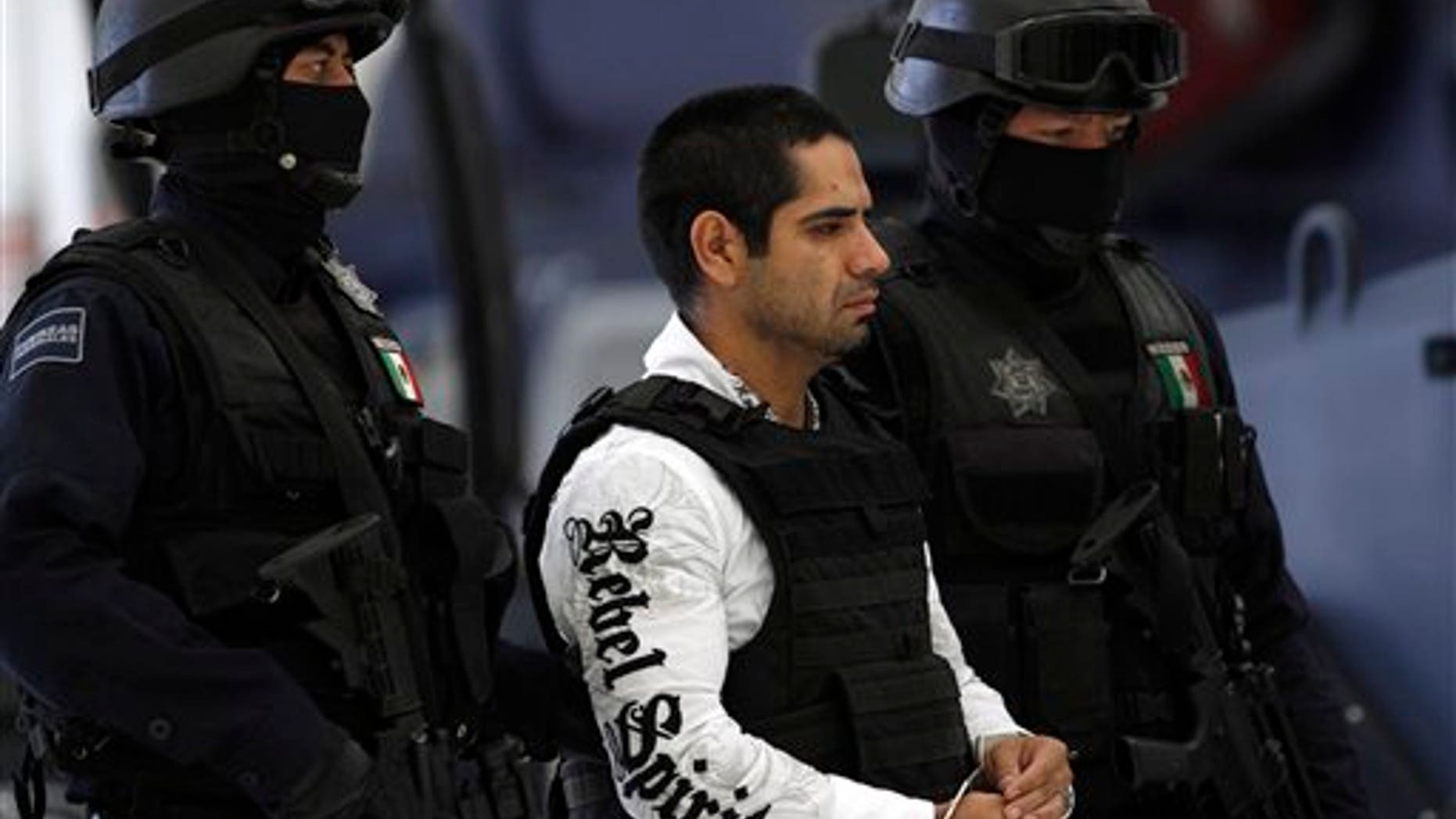 July 31: Jose Antonio Acosta Hernandez, 33, is presented to the media by federal police officers in Mexico City. According to federal officials, Acosta, nicknamed "El Diego," is a key drug cartel figure, who acknowledged ordering 1,500 killings. He is also a suspect in last year's slaying of a U.S. consulate employee near a border crossing in Ciudad Juarez.