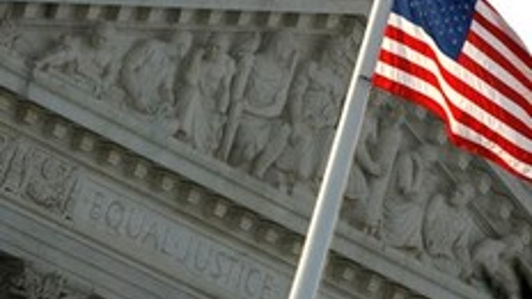 WASHINGTON - AUGUST 07: The U.S. flag flies in front of the West Pediment of the Supreme Court building on August 7, 2009 in Washington, DC. Judge Sonia Sotomayor will be sworn in as the 111th justice of the Supreme Court on Saturday. (Photo by Chip Somodevilla/Getty Images)
