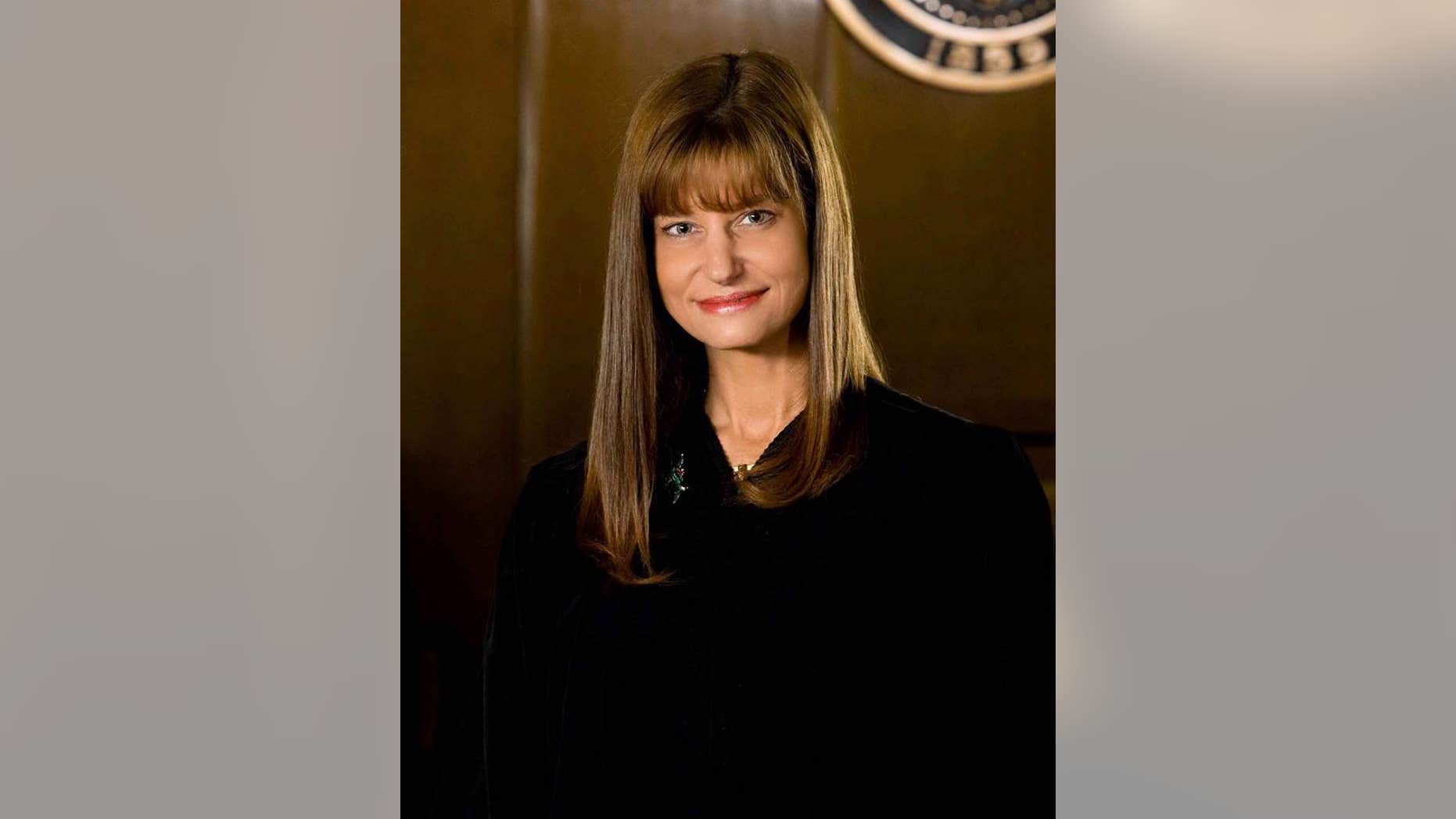 Judge Susie Norby said she offered to pay for courtroom damage she caused, but county officials said the cost was negligible.