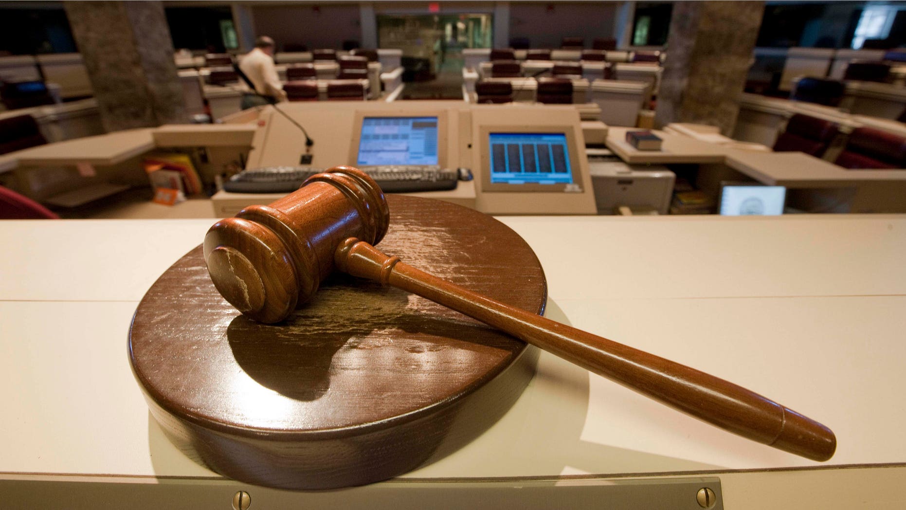 The gavel stands ready as Alabama House Public Information Officer Clay Redden, rear, makes preparations House chamber in Montgomery, Ala., on Friday, Dec. 3, 2010 a for the special session on ethics legislation called by Gov. Bob Riley. The lawmakers come into session next Wednesday. (AP Photo/Dave Martin)