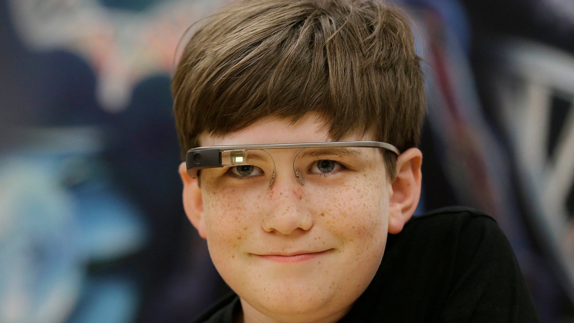 Julian Brown smiles while wearing Google Glass glasses and talking with Jena Daniels, a clinical research coordinator at The Wall Lab in Stanford, Calif., Wednesday, June 22, 2016.